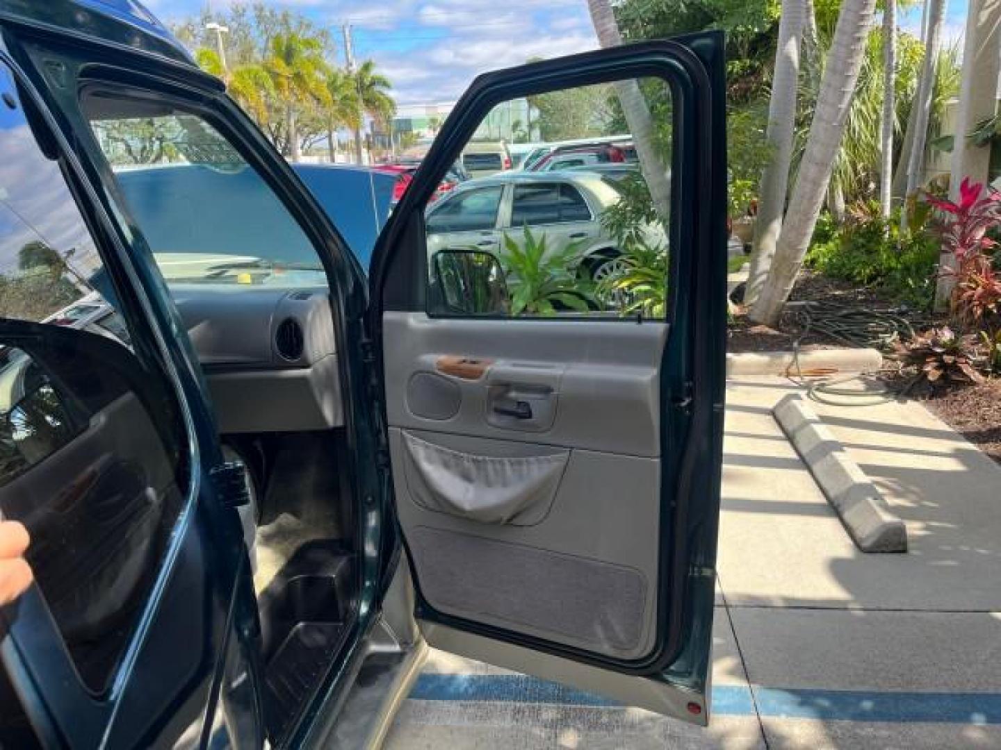 1999 Emerald Green Metallic /Medium Graphite Ford Econoline CONVERSION Van 1 FL LOW MILES 84,946 (1FDRE14L1XH) with an 5.4L SOHC SEFI V8 Triton Engine engine, Automatic transmission, located at 4701 North Dixie Hwy, Pompano Beach, FL, 33064, (954) 422-2889, 26.240938, -80.123474 - 1999 FORD ECONOLINE E150 ROAD READY TRAVEL READY VIN: 1FDRE14L1XHB78994 NO ACCIDENTS TV WITH VCR VAN NO RECALLS 5.4L V8 F SOHC 16V 1 OWNER FLORIDA 5.4L V8 GASOLINE STARCRAFT CONVERSION LOW MILES 84,946 REAR WHEEL DRIVE POWER LEATHER SEATS POPWER MIRRORS ABS Brakes AM/FM Stereo Air Conditioning Alloy - Photo#11