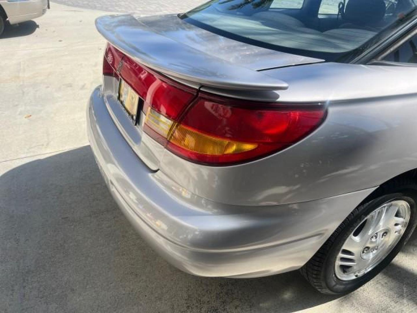 1999 Silver /Grey Saturn SC 3dr LOW MILES 53,616 (1G8ZY1276XZ) with an 1.9L DOHC SPFI 16-Valve L4 Aluminum Engine engine, Automatic transmission, located at 4701 North Dixie Hwy, Pompano Beach, FL, 33064, (954) 422-2889, 26.240938, -80.123474 - 1999 SATURN S-SERIES SC2 ROAD READY 1.9L L4 VIN: 1G8ZY1276XZ371017 NO RECALLS 36 MPG COUPE 3 DR LOW MILES 53,616 1.9L I4 F DOHC 16V 21 SERVICE RECORDS GASOLINE POWER SUNROOF FRONT WHEEL DRIVE POWER MIRRORS THIS IS ONE OF THE NICEST SATURN'S WE HAVE EVER LISTED RETIREE NORTH CAROLINA TITLE THIS IS TH - Photo#88