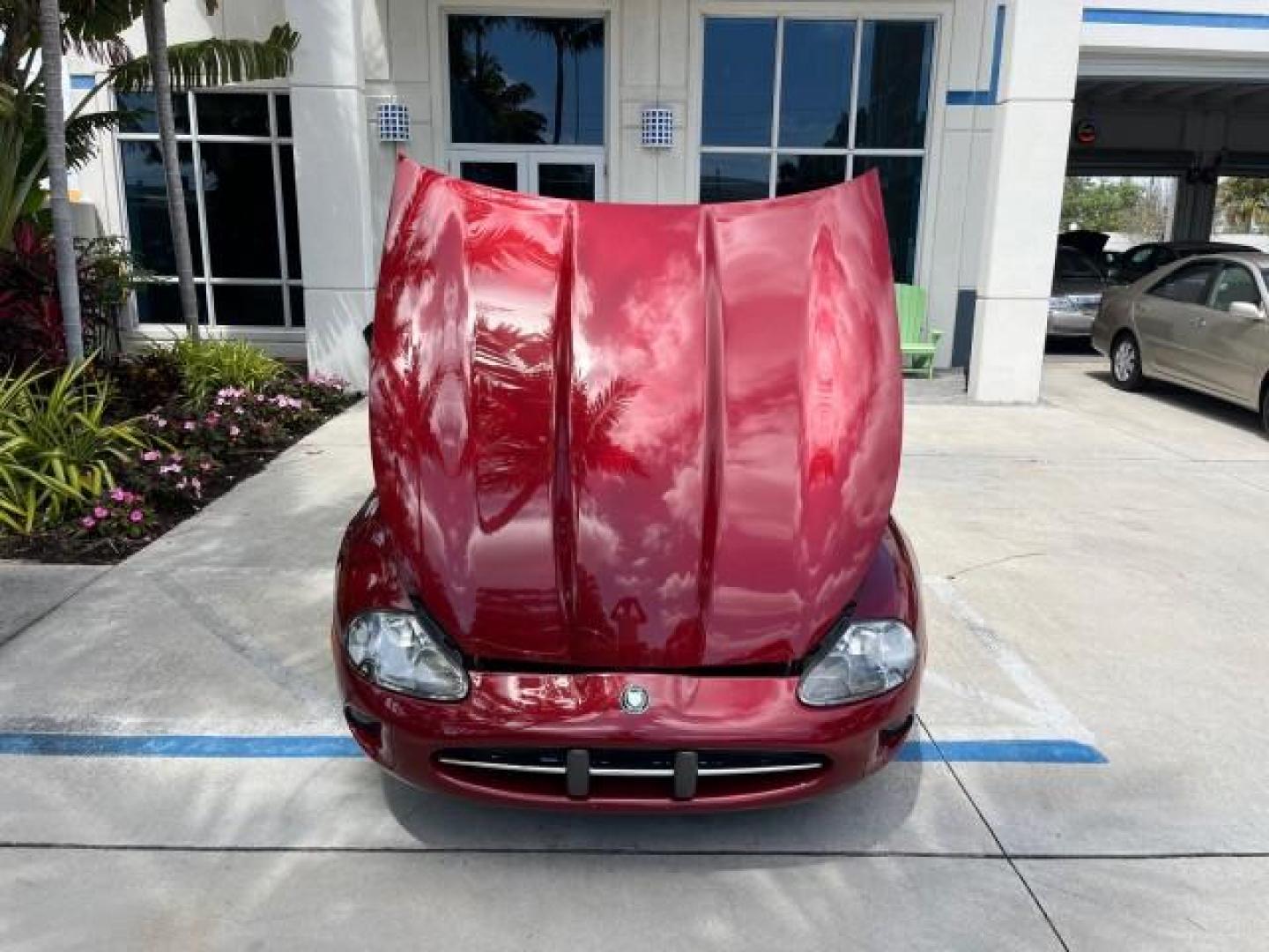 1999 Carnival Red /Oatmeal Jaguar XK8 LOW MILES 25,299 (SAJGX204XXC) with an 4.0L DOHC SPFI 32-Valve V8 Aluminum Alloy Engine engine, Automatic transmission, located at 4701 North Dixie Hwy, Pompano Beach, FL, 33064, (954) 422-2889, 26.240938, -80.123474 - 1999 JAGUAR XK-SERIES XK8 NEW $73,550 ROAD READY VIN: SAJGX204XXC033817 NO ACCIDENTS NO RECALLS CONVERTIBLE FLORIDA OWNER 4.OL V8 4.0L V8 F DOHC 24V LOW MILES 25,299 GASOLINE POWER CONVERTIBLE TOP REAR WHEEL DRIVE 14 SERVICE RECORDS POWER LEATHER SEATS Alloy Wheels Memory Seat(s) Leather Seats Soft - Photo#56