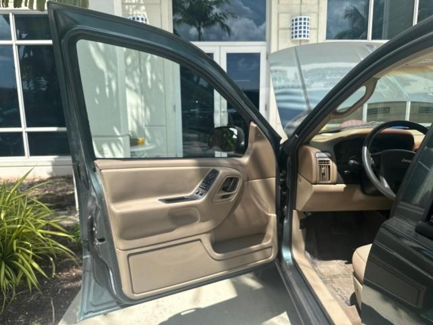 2002 Onyx Green Pearl /Sandstone Jeep Grand Cherokee 4w4 Laredo LOW MILES 87,762 (1J4GW48S42C) with an 4.0L SMFI I6 Power Tech Engine engine, Automatic transmission, located at 4701 North Dixie Hwy, Pompano Beach, FL, 33064, (954) 422-2889, 26.240938, -80.123474 - OUR WEBPAGE FLORIDACARS1.COM HAS OVER 100 PHOTOS AND FREE CARFAX LINK 2002 JEEP GRAND CHEROKEE LAREDO ROAD READY 4.0L V6 VIN: 1J4GW48S42C308150 NO ACCIDENTS 4 DOOR WAGON/SPORT UTILITY NO RECALLS 4X4 4.0L I6 F TOW PKG LOW MILES 87,762 GASOLINE POWER SEATS/MIRRORS REAR WHEEL DRIVE W/ 4X4 30 SERVICE RE - Photo#68