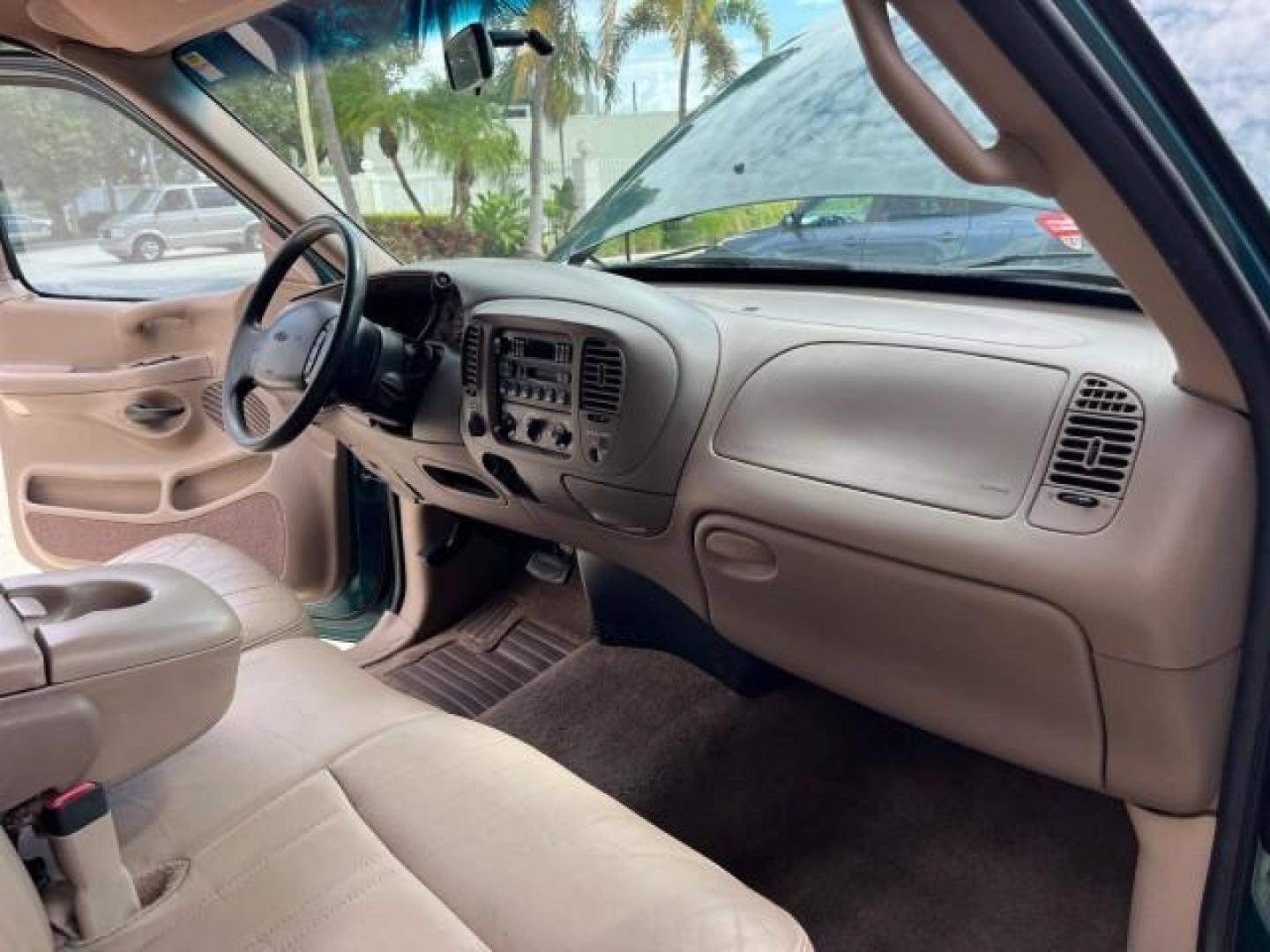 1997 Pacific Green (CC/Met) /Medium Prarie Tan Ford F-150 4WD Lariat LOW MILES 89,299 (1FTDX1860VK) with an 4.6L EFI OHC V8 Triton Engine engine, Automatic transmission, located at 4701 North Dixie Hwy, Pompano Beach, FL, 33064, (954) 422-2889, 26.240938, -80.123474 - OUR WEBPAGE FLORIDACARS1.COM HAS OVER 100 PHOTOS AND FREE CARFAX LINK 1997 FORD F-150 ROAD READY WORK READY VIN: 1FTDX1860VKA73358 NO ACCIDENTS 4X4 3 DOOR EXTENDED CAB PICKUP NO RECALLS 4.6L V8 4.6L V8 F 4X4 FLORIDA OWNER GASOLINE 20 SERVICE RECORDS POWER LEATHER SEATS REAR WHEEL DRIVE W/ 4X4 8 FT B - Photo#27