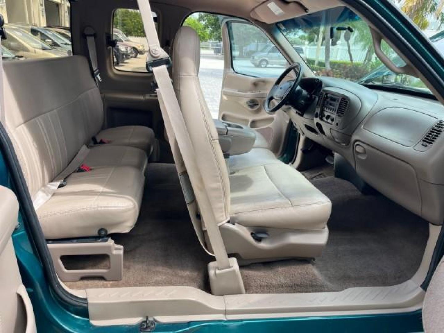 1997 Pacific Green (CC/Met) /Medium Prarie Tan Ford F-150 4WD Lariat LOW MILES 89,299 (1FTDX1860VK) with an 4.6L EFI OHC V8 Triton Engine engine, Automatic transmission, located at 4701 North Dixie Hwy, Pompano Beach, FL, 33064, (954) 422-2889, 26.240938, -80.123474 - OUR WEBPAGE FLORIDACARS1.COM HAS OVER 100 PHOTOS AND FREE CARFAX LINK 1997 FORD F-150 ROAD READY WORK READY VIN: 1FTDX1860VKA73358 NO ACCIDENTS 4X4 3 DOOR EXTENDED CAB PICKUP NO RECALLS 4.6L V8 4.6L V8 F 4X4 FLORIDA OWNER GASOLINE 20 SERVICE RECORDS POWER LEATHER SEATS REAR WHEEL DRIVE W/ 4X4 8 FT B - Photo#28