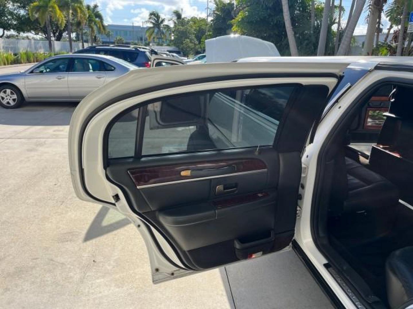 2009 Vibrant White /Black Lincoln Town Car Executive w/Limousine LO MI 79,993 (2L1FM88W09X) with an 4.6L SOHC EFI V8 Engine engine, Automatic transmission, located at 4701 North Dixie Hwy, Pompano Beach, FL, 33064, (954) 422-2889, 26.240938, -80.123474 - OUR WEBPAGE FLORIDACARS1.COM HAS OVER 100 PHOTOS AND FREE CARFAX LINK 2009 LINCOLN TOWN CAR EXECUTIVE L ROAD READY WORK READY VIN: 2L1FM88W09X601250 NO ACCIDENTS 4.6L V8 LIMOUSINE DA BRYAN COACH NO RECALLS 24 MPG 4.6L V8 F SOHC 16V 27 FT LONG LEATHER SEATS GASOLINE 7 PASSENGERS LOW MILES 79,993 REAR - Photo#13