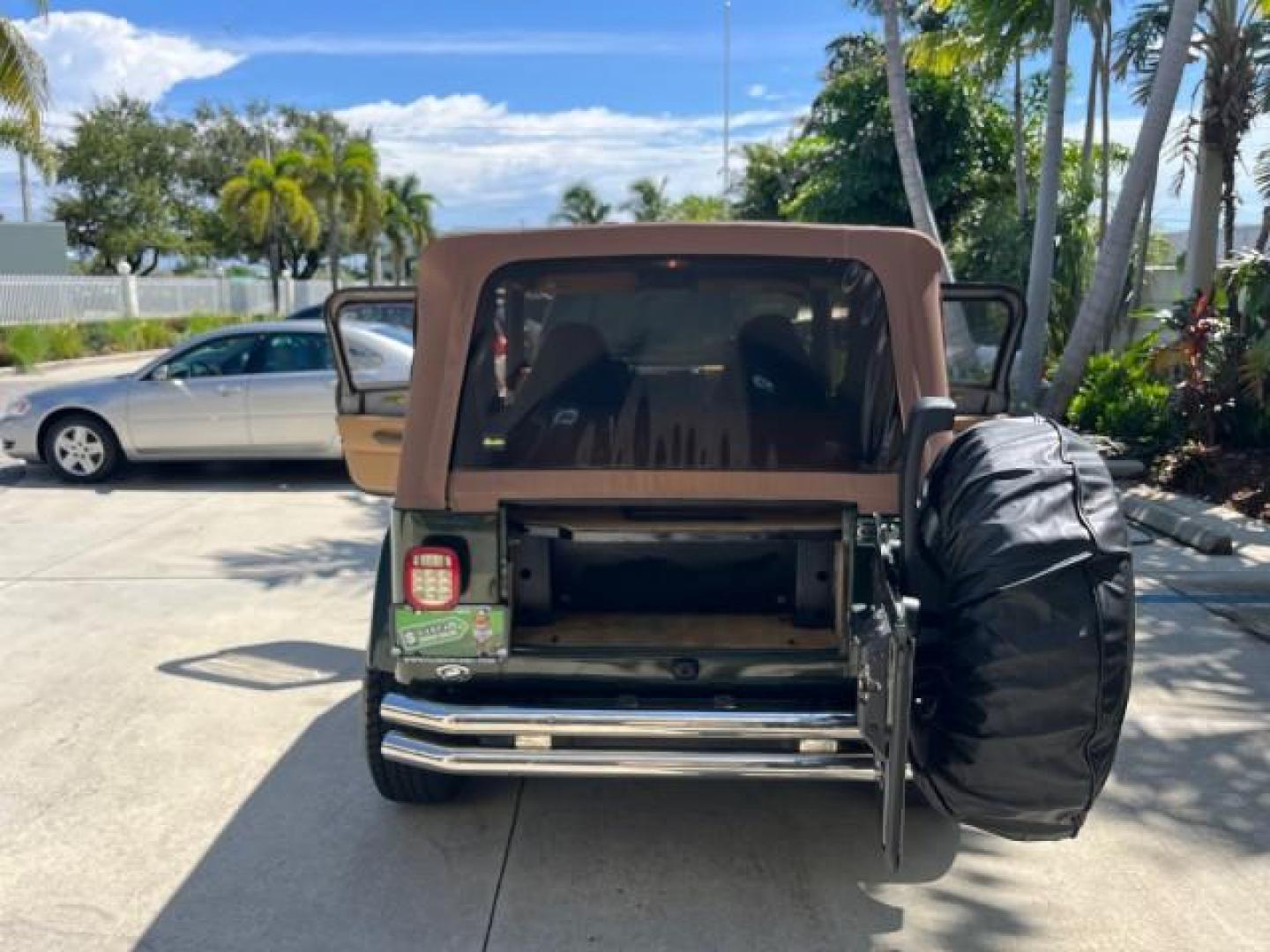 1998 Moss Green (PC) /Saddle Jeep Wrangler Sahara AUTO AC LOW MILES 60,233 (1J4FY49S2WP) with an 4.0L SMPI I6 Power Tech Engine engine, Automatic transmission, located at 4701 North Dixie Hwy, Pompano Beach, FL, 33064, (954) 422-2889, 26.240938, -80.123474 - OUR WEBPAGE FLORIDACARS1.COM HAS OVER 100 PHOTOS AND FREE CARFAX LINK 1998 JEEP WRANGLER SAHARA ROAD READY 4.0L I6 VIN: 1J4FY49S2WP723583 NO RECALLS 4X4 UTILITY (BLAZER, JIMMY, SCOUT, ETC.) LOW MILES 60,233 4.0L I6 F OHV FLORIDA OWNER GASOLINE CONVERTIBLE SOFT TOP REAR WHEEL DRIVE W/ 4X4 4X4 6 SERVI - Photo#15