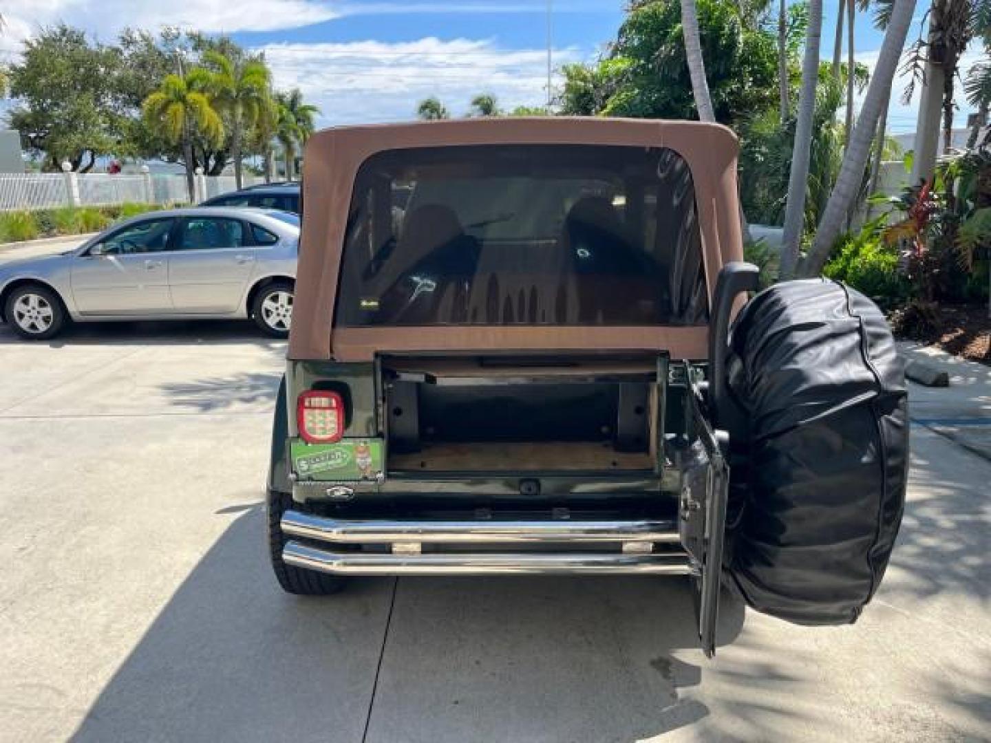 1998 Moss Green (PC) /Saddle Jeep Wrangler Sahara AUTO AC LOW MILES 60,233 (1J4FY49S2WP) with an 4.0L SMPI I6 Power Tech Engine engine, Automatic transmission, located at 4701 North Dixie Hwy, Pompano Beach, FL, 33064, (954) 422-2889, 26.240938, -80.123474 - OUR WEBPAGE FLORIDACARS1.COM HAS OVER 100 PHOTOS AND FREE CARFAX LINK 1998 JEEP WRANGLER SAHARA ROAD READY 4.0L I6 VIN: 1J4FY49S2WP723583 NO RECALLS 4X4 UTILITY (BLAZER, JIMMY, SCOUT, ETC.) LOW MILES 60,233 4.0L I6 F OHV FLORIDA OWNER GASOLINE CONVERTIBLE SOFT TOP REAR WHEEL DRIVE W/ 4X4 4X4 6 SERVI - Photo#49