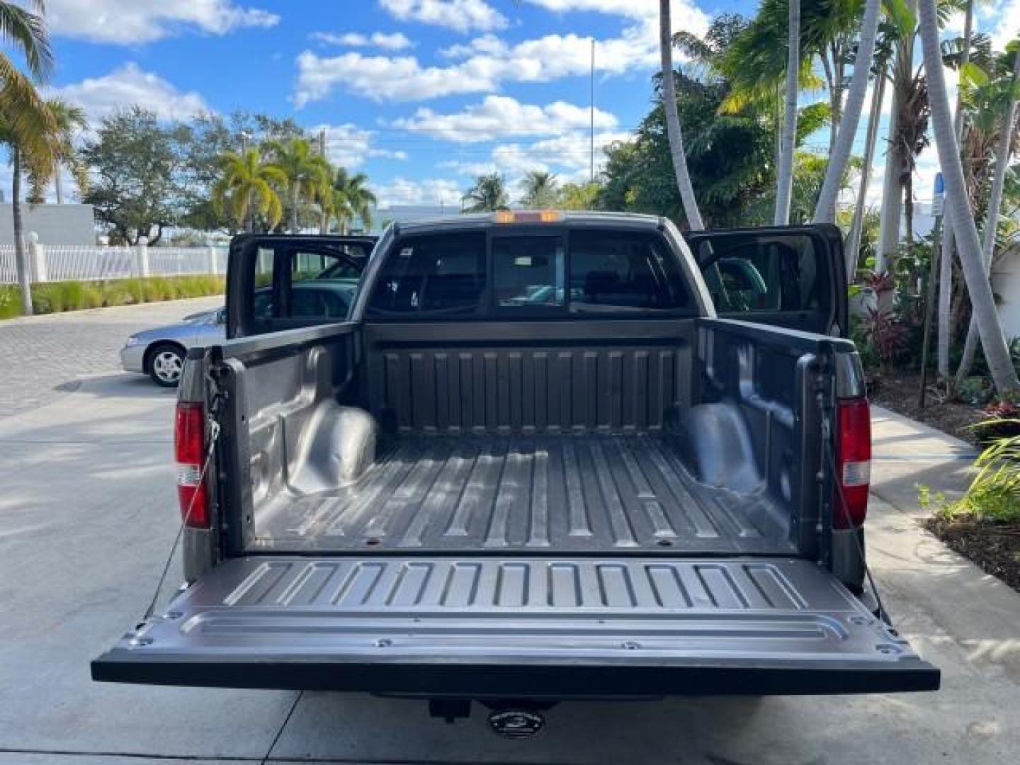 2005 Dark Shadow Grey Metallic /Black Ford F-150 1 FL FX4 4X4 LOW MILES 80,488 (1FTPW14535K) with an 5.4L 3v EFI V8 Engine engine, Automatic transmission, located at 4701 North Dixie Hwy, Pompano Beach, FL, 33064, (954) 422-2889, 26.240938, -80.123474 - OUR WEBPAGE FLORIDACARS1.COM HAS OVER 100 PHOTOS AND FREE CARFAX LINK 2005 FORD F-150 XLT ROAD READY 5.4L V8 VIN: 1FTPW14535KE86307 FX4 NO ACCIDENTS 4X4 CREW PICKUP BLUETOOTH NAVI NO RECALLS 1 OWNER FL 5.4L V8 F SOHC POWER SUNROOF 5,6FT BED LENGTH GASOLINE POWER LEATHER SEATS LOW MILES 80,488 REAR W - Photo#15