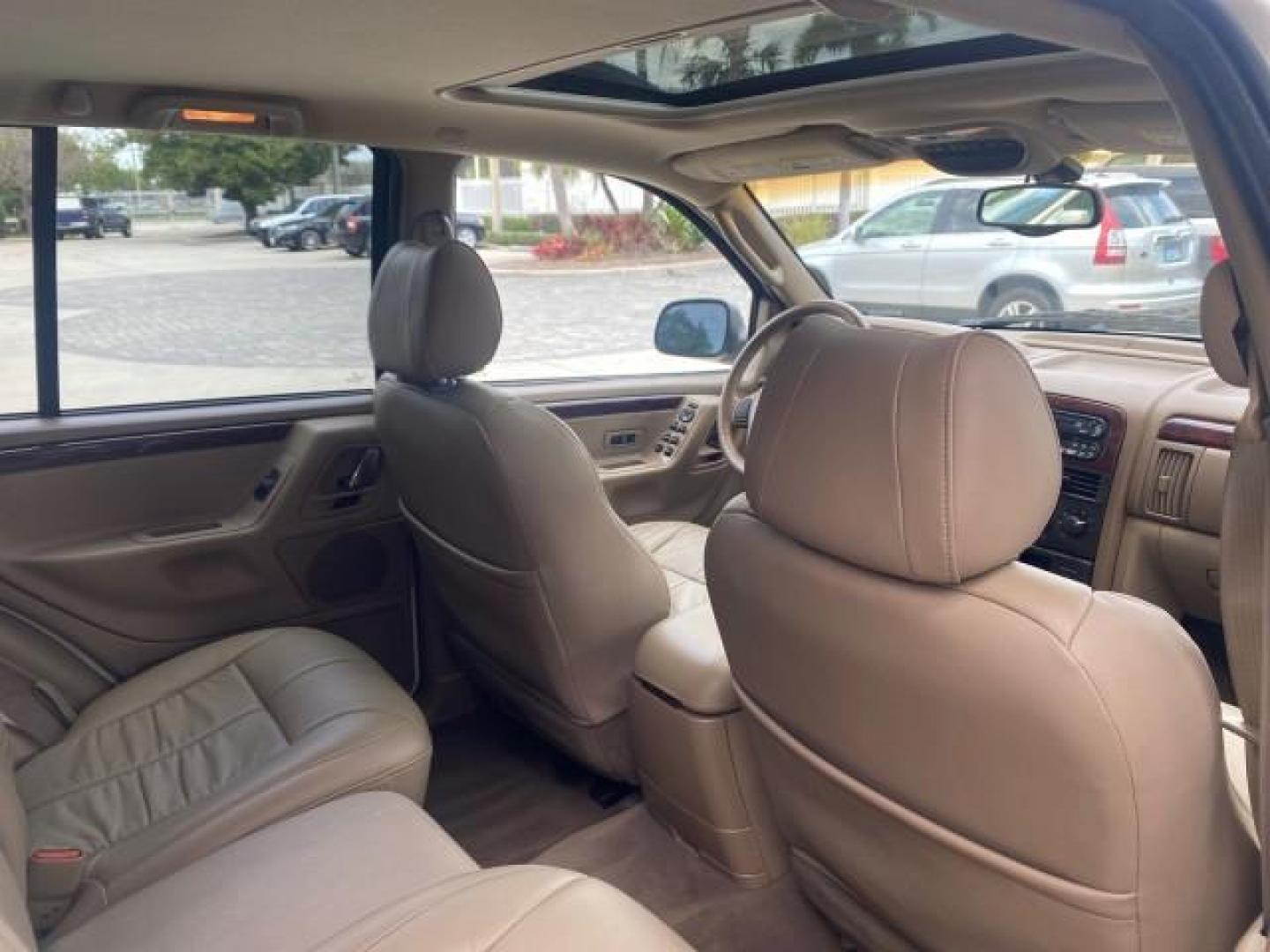 2004 Stone White /Sandstone Jeep Grand Cherokee Limited 4WD SUNROOF (1J8GW58N14C) with an 4.7L 8-Cyl Engine engine, Automatic transmission, located at 4701 North Dixie Hwy, Pompano Beach, FL, 33064, (954) 422-2889, 26.240938, -80.123474 - OUR WEBPAGE FLORIDACARS1.COM HAS OVER 100 PHOTOS AND FREE CARFAX LINK 2004 JEEP GRAND CHEROKEE LIMITED A TRUE CLASSIC WONT LAST IN STOCK VIN: 1J8GW58N14C199129 1 J 8 G W 5 8 N 1 4 C 1 9 9 1 2 9 4 DOOR WAGON/SPORT UTILITY 4.7L V8 F SOHC TOW PKG AND FRONT TOW HITCH WITH PLUG GASOLINE REAR WHEEL DRIVE - Photo#86