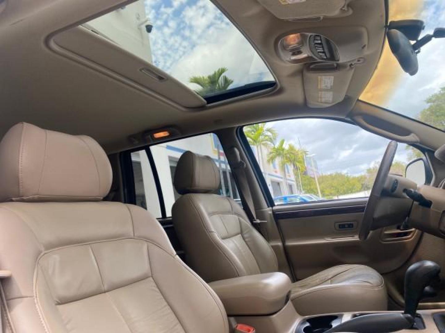 2004 Stone White /Sandstone Jeep Grand Cherokee Limited 4WD SUNROOF (1J8GW58N14C) with an 4.7L 8-Cyl Engine engine, Automatic transmission, located at 4701 North Dixie Hwy, Pompano Beach, FL, 33064, (954) 422-2889, 26.240938, -80.123474 - OUR WEBPAGE FLORIDACARS1.COM HAS OVER 100 PHOTOS AND FREE CARFAX LINK 2004 JEEP GRAND CHEROKEE LIMITED A TRUE CLASSIC WONT LAST IN STOCK VIN: 1J8GW58N14C199129 1 J 8 G W 5 8 N 1 4 C 1 9 9 1 2 9 4 DOOR WAGON/SPORT UTILITY 4.7L V8 F SOHC TOW PKG AND FRONT TOW HITCH WITH PLUG GASOLINE REAR WHEEL DRIVE - Photo#94