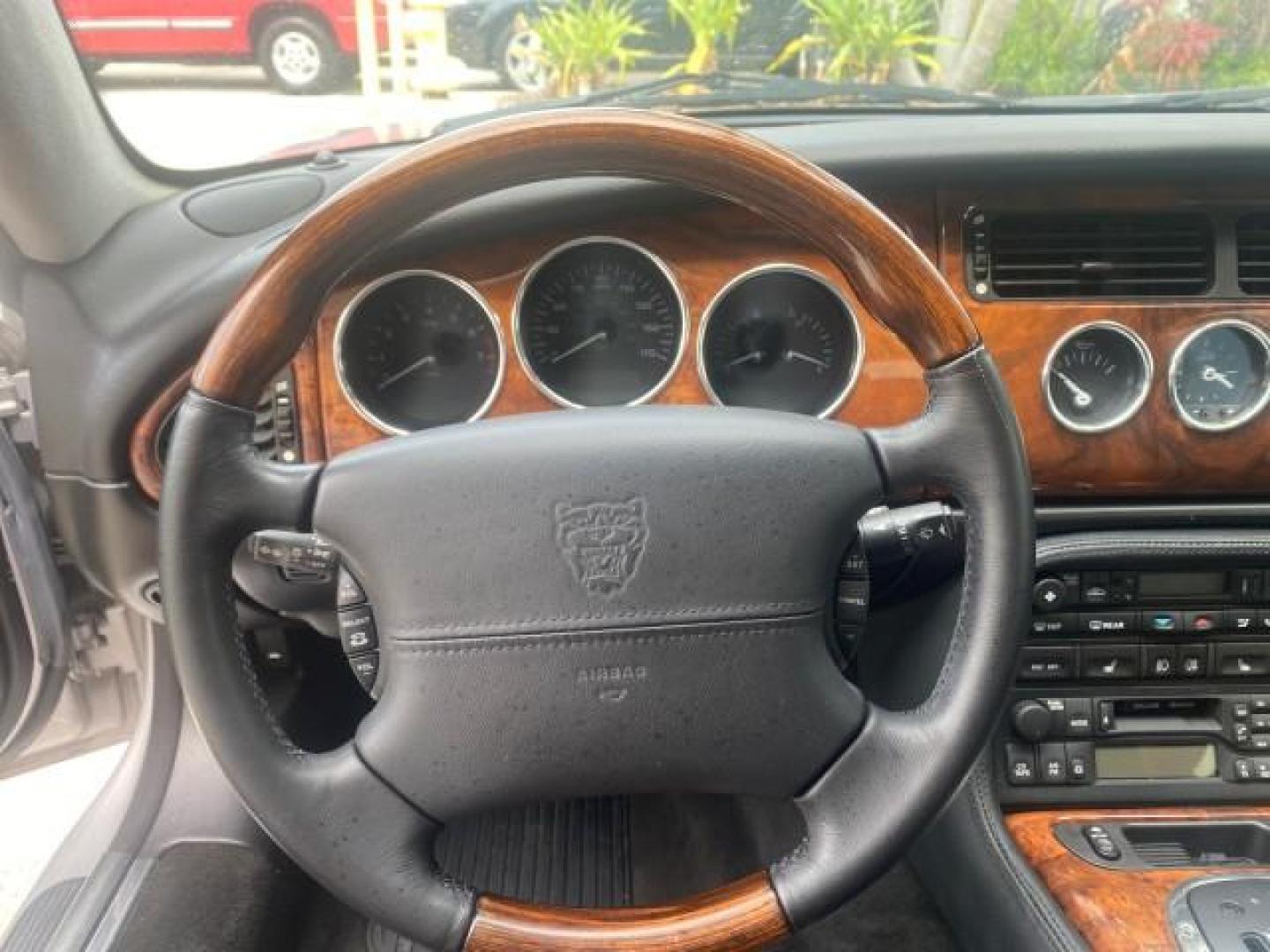 2004 Quartz /Charcoal Jaguar XK8 CONV LOW MILES 22,128 (SAJDA42CX42) with an 4.2L DOHC EFI 32-Valve Aluminum Alloy V8 Engine engine, Automatic transmission, located at 4701 North Dixie Hwy, Pompano Beach, FL, 33064, (954) 422-2889, 26.240938, -80.123474 - OUR WEBPAGE FLORIDACARS1.COM HAS OVER 100 PHOTOS AND FREE CARFAX LINK 2004 JAGUAR XK-SERIES XK8 $ 75,530 NEW VIN: SAJDA42CX42A37634 S A J D A 4 2 C X 4 2 A 3 7 6 3 4 CONVERTIBLE 4.2L V8 F DOHC GASOLINE REAR WHEEL DRIVE TOP WORKS GREAT! TIRES ARE LIKE NEW! Top Features Alloy Wheels Leather Seats Alpi - Photo#42