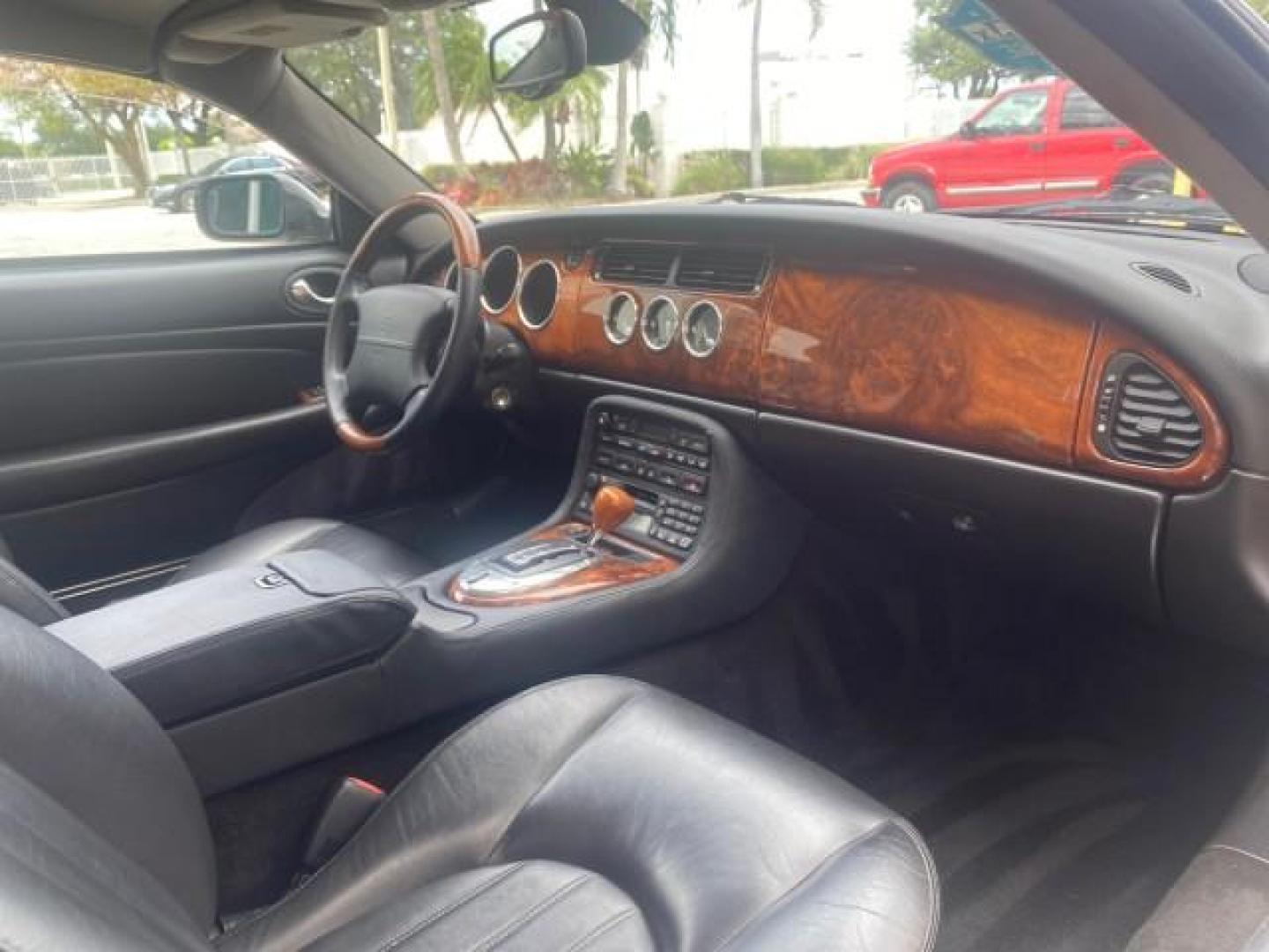 2004 Quartz /Charcoal Jaguar XK8 CONV LOW MILES 22,128 (SAJDA42CX42) with an 4.2L DOHC EFI 32-Valve Aluminum Alloy V8 Engine engine, Automatic transmission, located at 4701 North Dixie Hwy, Pompano Beach, FL, 33064, (954) 422-2889, 26.240938, -80.123474 - OUR WEBPAGE FLORIDACARS1.COM HAS OVER 100 PHOTOS AND FREE CARFAX LINK 2004 JAGUAR XK-SERIES XK8 $ 75,530 NEW VIN: SAJDA42CX42A37634 S A J D A 4 2 C X 4 2 A 3 7 6 3 4 CONVERTIBLE 4.2L V8 F DOHC GASOLINE REAR WHEEL DRIVE TOP WORKS GREAT! TIRES ARE LIKE NEW! Top Features Alloy Wheels Leather Seats Alpi - Photo#95