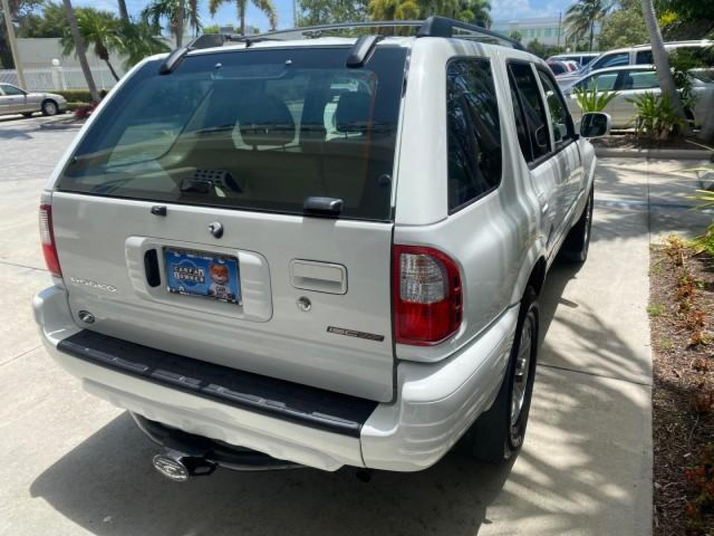 2001 Alpine White /Beige Isuzu Rodeo LSE LOW MILES 78,391 (4S2CK58W814) with an 3.2L DOHC MFI 24-Valve V6 Engine engine, Automatic transmission, located at 4701 North Dixie Hwy, Pompano Beach, FL, 33064, (954) 422-2889, 26.240938, -80.123474 - OUR WEBPAGE FLORIDACARS1.COM HAS OVER 100 PHOTOS AND FREE CARFAX LINK 2001 ISUZU RODEO LSE ROAD READY 3.2L V6 VIN: 4S2CK58W814310263 NO ACCIDENTS 4 DOOR WAGON/SPORT UTILITY NO RECALLS SUNROOF 3.2L DOHC V6 FLORIDA OWNER GASOLINE LOW MILES 78,876 REAR WHEEL DRIVE POWER LEATHER SEATS Approach Lights Cr - Photo#83