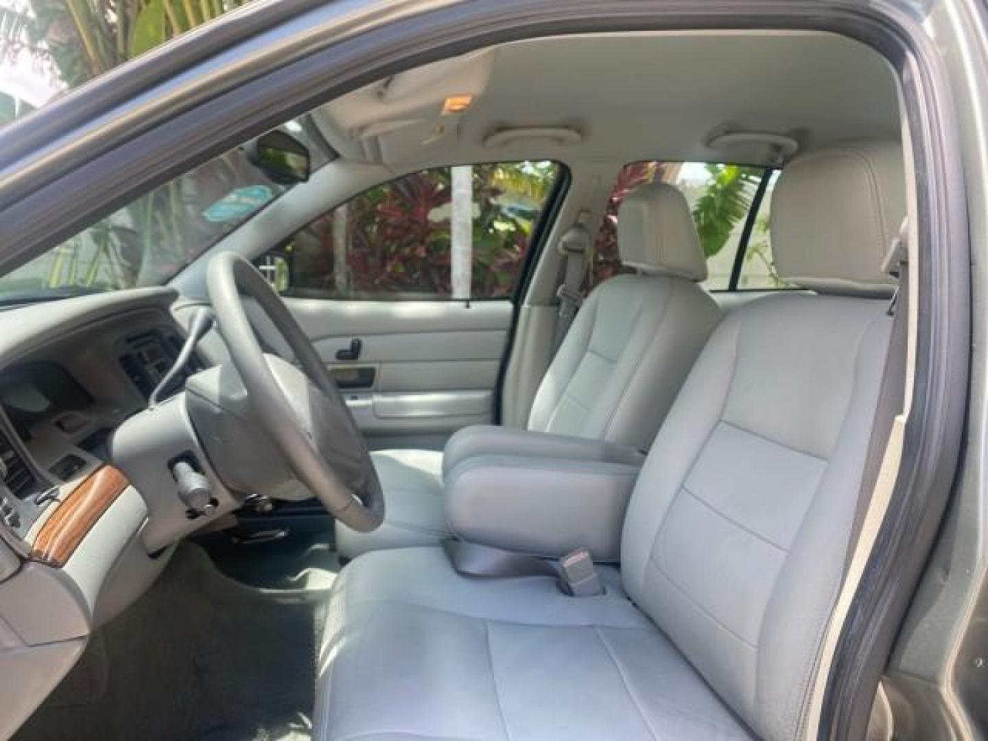 2004 Medium Titanium Metallic /Light Flint Ford Crown Victoria LX Sport LOW MILES 75,511 FL (2FAFP74W24X) with an 4.6L SEFI OHC V8 Engine engine, Automatic transmission, located at 4701 North Dixie Hwy, Pompano Beach, FL, 33064, (954) 422-2889, 26.240938, -80.123474 - OUR WEBPAGE FLORIDACARS1.COM HAS OVER 100 PHOTOS AND FREE CARFAX LINK 2004 FORD CROWN VICTORIA LX DUAL EXHAUST RARE FIND VIN: 2FAFP74W24X150704 2 F A F P 7 4 W 2 4 X 1 5 0 7 0 4 SEDAN 4 DR 4.6L V8 F GASOLINE REAR WHEEL DRIVE Top Features Alloy Wheels Leather Seats Basic Features ABS Brakes AM/FM Ste - Photo#32