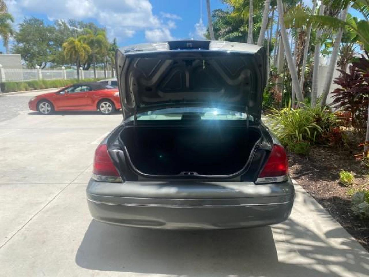 2004 Medium Titanium Metallic /Light Flint Ford Crown Victoria LX Sport LOW MILES 75,511 FL (2FAFP74W24X) with an 4.6L SEFI OHC V8 Engine engine, Automatic transmission, located at 4701 North Dixie Hwy, Pompano Beach, FL, 33064, (954) 422-2889, 26.240938, -80.123474 - OUR WEBPAGE FLORIDACARS1.COM HAS OVER 100 PHOTOS AND FREE CARFAX LINK 2004 FORD CROWN VICTORIA LX DUAL EXHAUST RARE FIND VIN: 2FAFP74W24X150704 2 F A F P 7 4 W 2 4 X 1 5 0 7 0 4 SEDAN 4 DR 4.6L V8 F GASOLINE REAR WHEEL DRIVE Top Features Alloy Wheels Leather Seats Basic Features ABS Brakes AM/FM Ste - Photo#72