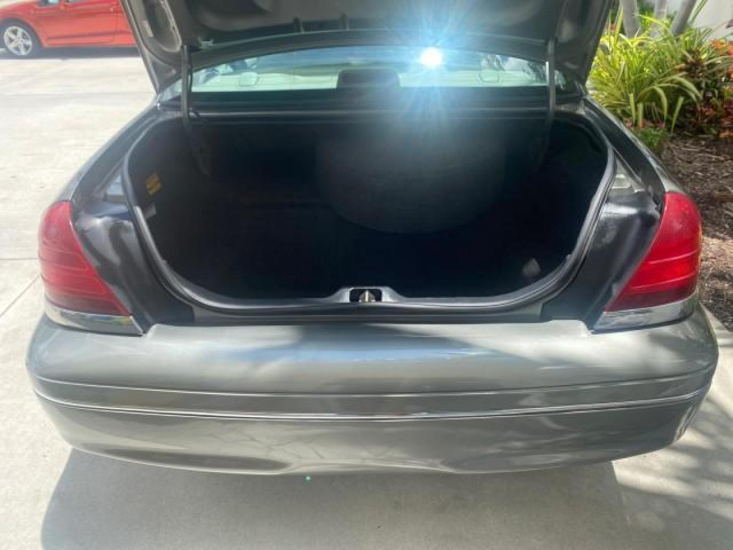 2004 Medium Titanium Metallic /Light Flint Ford Crown Victoria LX Sport LOW MILES 75,511 FL (2FAFP74W24X) with an 4.6L SEFI OHC V8 Engine engine, Automatic transmission, located at 4701 North Dixie Hwy, Pompano Beach, FL, 33064, (954) 422-2889, 26.240938, -80.123474 - OUR WEBPAGE FLORIDACARS1.COM HAS OVER 100 PHOTOS AND FREE CARFAX LINK 2004 FORD CROWN VICTORIA LX DUAL EXHAUST RARE FIND VIN: 2FAFP74W24X150704 2 F A F P 7 4 W 2 4 X 1 5 0 7 0 4 SEDAN 4 DR 4.6L V8 F GASOLINE REAR WHEEL DRIVE Top Features Alloy Wheels Leather Seats Basic Features ABS Brakes AM/FM Ste - Photo#73