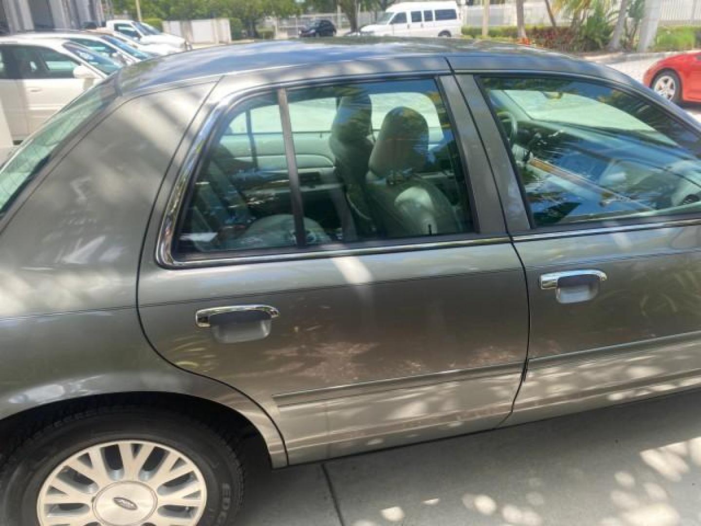 2004 Medium Titanium Metallic /Light Flint Ford Crown Victoria LX Sport LOW MILES 75,511 FL (2FAFP74W24X) with an 4.6L SEFI OHC V8 Engine engine, Automatic transmission, located at 4701 North Dixie Hwy, Pompano Beach, FL, 33064, (954) 422-2889, 26.240938, -80.123474 - OUR WEBPAGE FLORIDACARS1.COM HAS OVER 100 PHOTOS AND FREE CARFAX LINK 2004 FORD CROWN VICTORIA LX DUAL EXHAUST RARE FIND VIN: 2FAFP74W24X150704 2 F A F P 7 4 W 2 4 X 1 5 0 7 0 4 SEDAN 4 DR 4.6L V8 F GASOLINE REAR WHEEL DRIVE Top Features Alloy Wheels Leather Seats Basic Features ABS Brakes AM/FM Ste - Photo#81