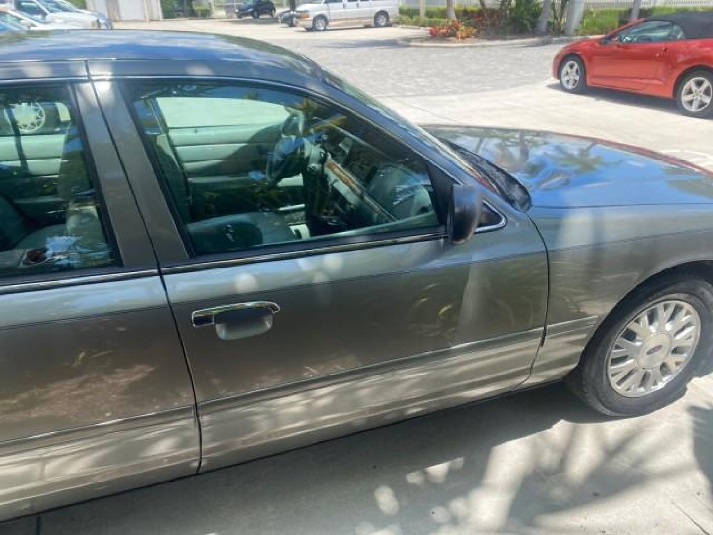 2004 Medium Titanium Metallic /Light Flint Ford Crown Victoria LX Sport LOW MILES 75,511 FL (2FAFP74W24X) with an 4.6L SEFI OHC V8 Engine engine, Automatic transmission, located at 4701 North Dixie Hwy, Pompano Beach, FL, 33064, (954) 422-2889, 26.240938, -80.123474 - OUR WEBPAGE FLORIDACARS1.COM HAS OVER 100 PHOTOS AND FREE CARFAX LINK 2004 FORD CROWN VICTORIA LX DUAL EXHAUST RARE FIND VIN: 2FAFP74W24X150704 2 F A F P 7 4 W 2 4 X 1 5 0 7 0 4 SEDAN 4 DR 4.6L V8 F GASOLINE REAR WHEEL DRIVE Top Features Alloy Wheels Leather Seats Basic Features ABS Brakes AM/FM Ste - Photo#89