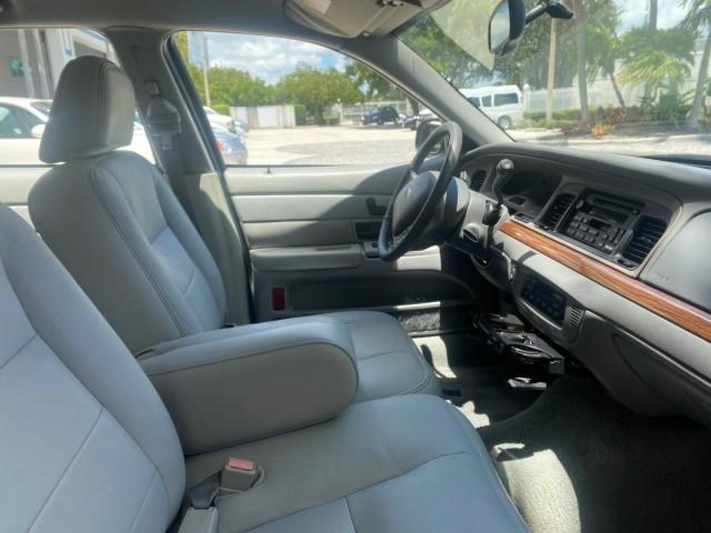 2004 Medium Titanium Metallic /Light Flint Ford Crown Victoria LX Sport LOW MILES 75,511 FL (2FAFP74W24X) with an 4.6L SEFI OHC V8 Engine engine, Automatic transmission, located at 4701 North Dixie Hwy, Pompano Beach, FL, 33064, (954) 422-2889, 26.240938, -80.123474 - OUR WEBPAGE FLORIDACARS1.COM HAS OVER 100 PHOTOS AND FREE CARFAX LINK 2004 FORD CROWN VICTORIA LX DUAL EXHAUST RARE FIND VIN: 2FAFP74W24X150704 2 F A F P 7 4 W 2 4 X 1 5 0 7 0 4 SEDAN 4 DR 4.6L V8 F GASOLINE REAR WHEEL DRIVE Top Features Alloy Wheels Leather Seats Basic Features ABS Brakes AM/FM Ste - Photo#95