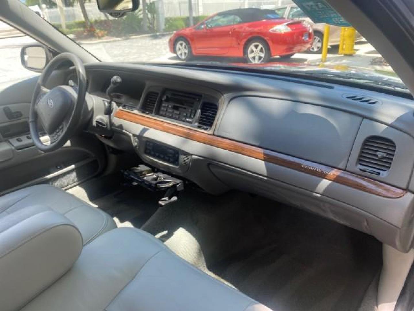 2004 Medium Titanium Metallic /Light Flint Ford Crown Victoria LX Sport LOW MILES 75,511 FL (2FAFP74W24X) with an 4.6L SEFI OHC V8 Engine engine, Automatic transmission, located at 4701 North Dixie Hwy, Pompano Beach, FL, 33064, (954) 422-2889, 26.240938, -80.123474 - OUR WEBPAGE FLORIDACARS1.COM HAS OVER 100 PHOTOS AND FREE CARFAX LINK 2004 FORD CROWN VICTORIA LX DUAL EXHAUST RARE FIND VIN: 2FAFP74W24X150704 2 F A F P 7 4 W 2 4 X 1 5 0 7 0 4 SEDAN 4 DR 4.6L V8 F GASOLINE REAR WHEEL DRIVE Top Features Alloy Wheels Leather Seats Basic Features ABS Brakes AM/FM Ste - Photo#97