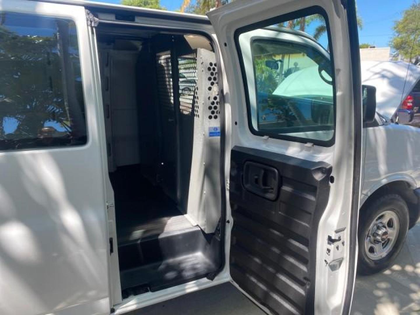 2004 Summit White /Medium Dark Pewter GMC Savana Cargo Van 1 OWNER FL (1GTFG15X141) with an 4.3L Vortec 4300 V6 MFI Engine engine, Automatic transmission, located at 4701 North Dixie Hwy, Pompano Beach, FL, 33064, (954) 422-2889, 26.240938, -80.123474 - OUR WEBPAGE FLORIDACARS1.COM HAS OVER 100 PHOTOS AND FREE CARFAX LINK 2004 GMC SAVANA 1500 THIS VAN IS LIKE NEW! VIN: 1GTFG15X141181482 1 G T F G 1 5 X 1 4 1 1 8 1 4 8 2 VAN 4.3L V6 F GASOLINE REAR WHEEL DRIVE Top Features Conversion Van Vinyl Seats Basic Features ABS Brakes AM/FM Stereo Air Conditi - Photo#13