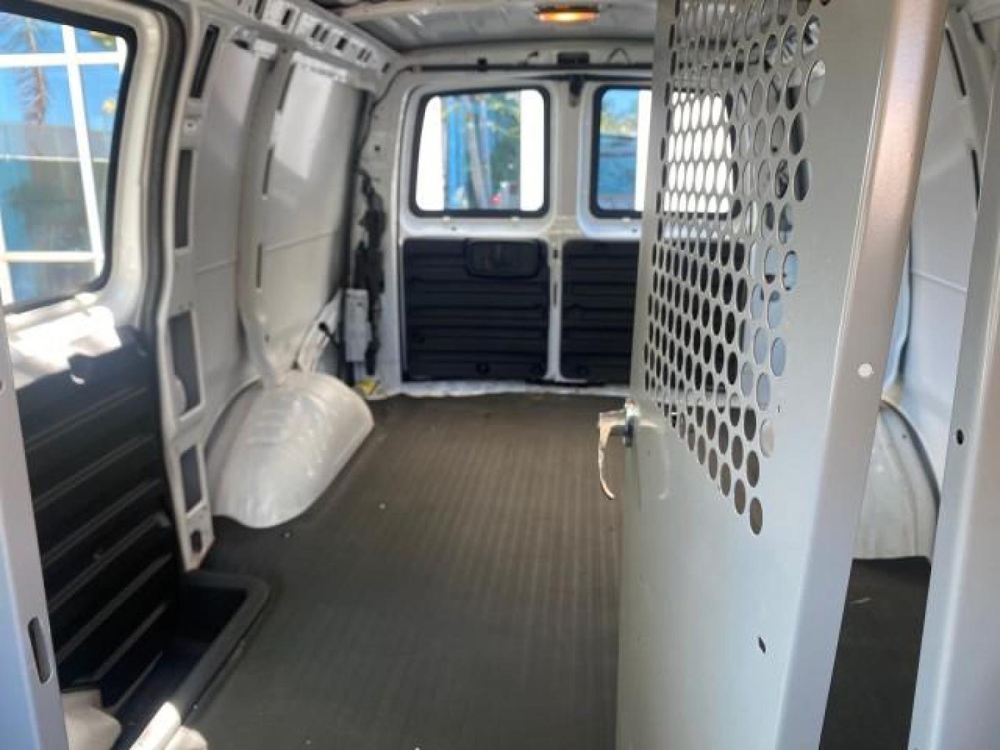 2004 Summit White /Medium Dark Pewter GMC Savana Cargo Van 1 OWNER FL (1GTFG15X141) with an 4.3L Vortec 4300 V6 MFI Engine engine, Automatic transmission, located at 4701 North Dixie Hwy, Pompano Beach, FL, 33064, (954) 422-2889, 26.240938, -80.123474 - OUR WEBPAGE FLORIDACARS1.COM HAS OVER 100 PHOTOS AND FREE CARFAX LINK 2004 GMC SAVANA 1500 THIS VAN IS LIKE NEW! VIN: 1GTFG15X141181482 1 G T F G 1 5 X 1 4 1 1 8 1 4 8 2 VAN 4.3L V6 F GASOLINE REAR WHEEL DRIVE Top Features Conversion Van Vinyl Seats Basic Features ABS Brakes AM/FM Stereo Air Conditi - Photo#59