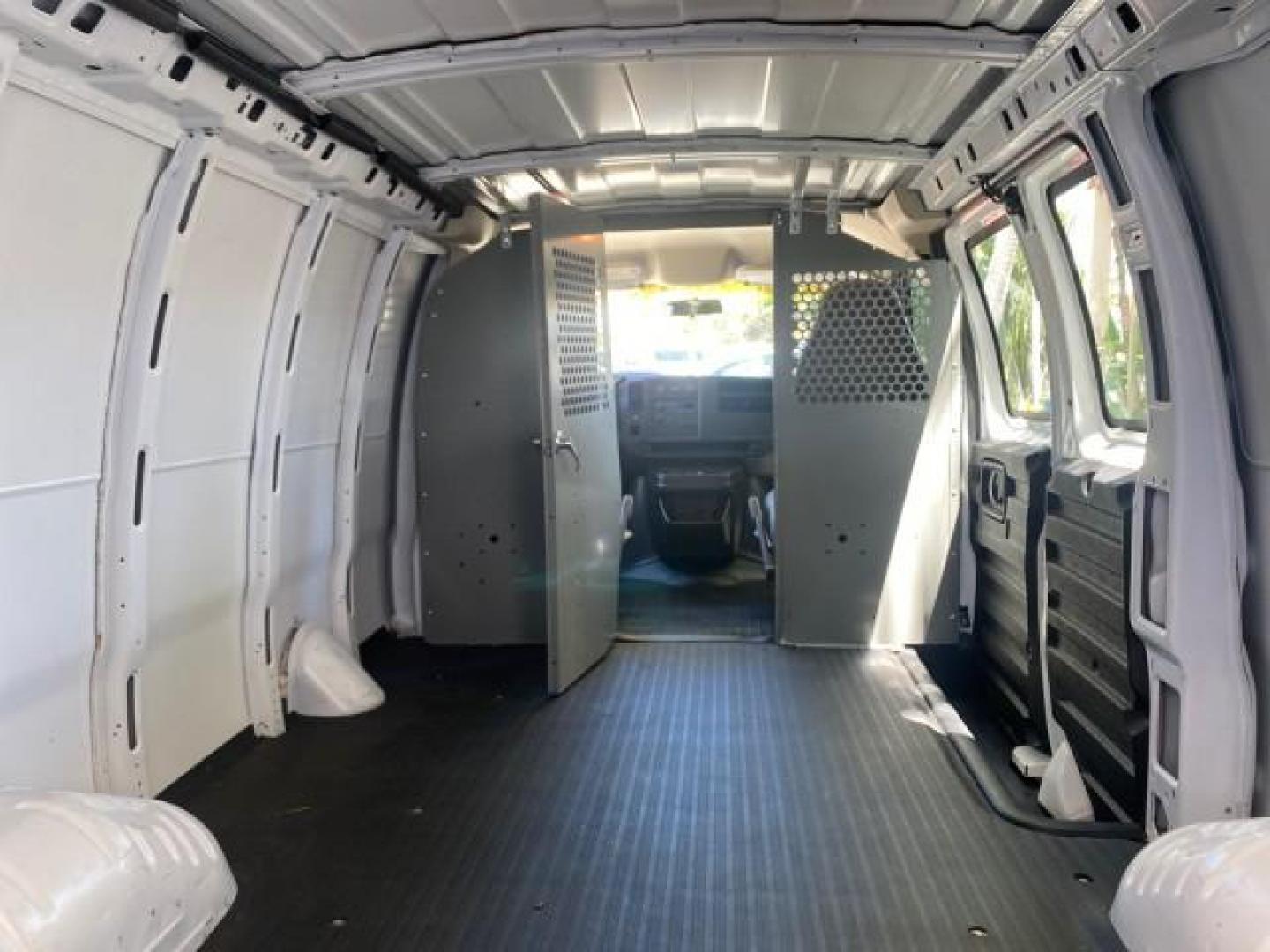 2004 Summit White /Medium Dark Pewter GMC Savana Cargo Van 1 OWNER FL (1GTFG15X141) with an 4.3L Vortec 4300 V6 MFI Engine engine, Automatic transmission, located at 4701 North Dixie Hwy, Pompano Beach, FL, 33064, (954) 422-2889, 26.240938, -80.123474 - OUR WEBPAGE FLORIDACARS1.COM HAS OVER 100 PHOTOS AND FREE CARFAX LINK 2004 GMC SAVANA 1500 THIS VAN IS LIKE NEW! VIN: 1GTFG15X141181482 1 G T F G 1 5 X 1 4 1 1 8 1 4 8 2 VAN 4.3L V6 F GASOLINE REAR WHEEL DRIVE Top Features Conversion Van Vinyl Seats Basic Features ABS Brakes AM/FM Stereo Air Conditi - Photo#79