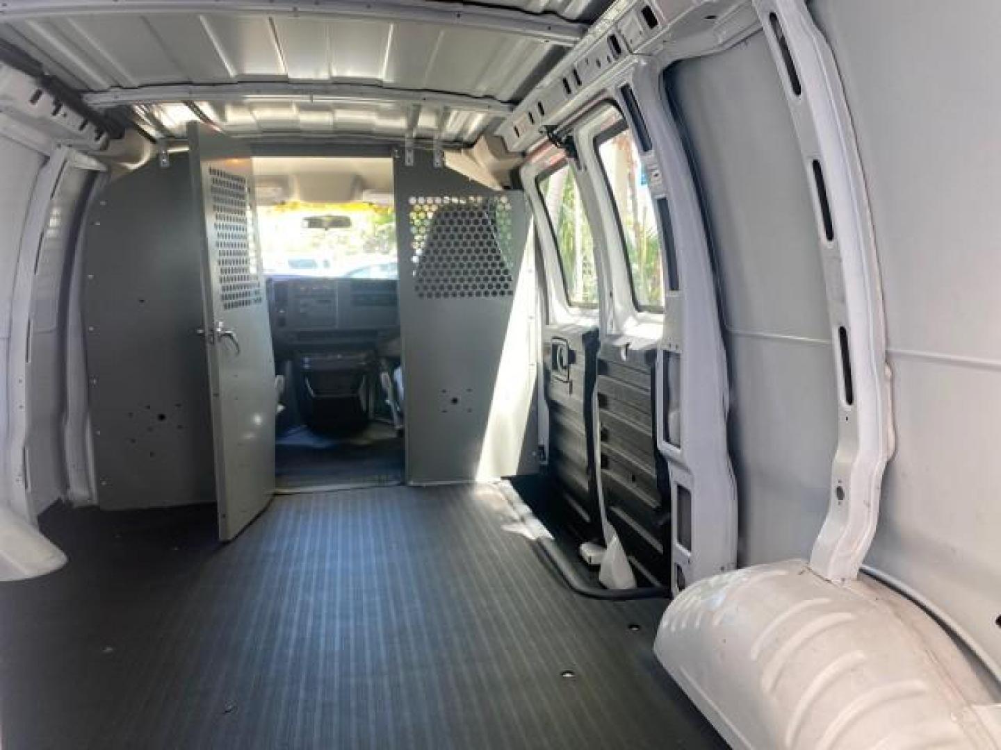 2004 Summit White /Medium Dark Pewter GMC Savana Cargo Van 1 OWNER FL (1GTFG15X141) with an 4.3L Vortec 4300 V6 MFI Engine engine, Automatic transmission, located at 4701 North Dixie Hwy, Pompano Beach, FL, 33064, (954) 422-2889, 26.240938, -80.123474 - OUR WEBPAGE FLORIDACARS1.COM HAS OVER 100 PHOTOS AND FREE CARFAX LINK 2004 GMC SAVANA 1500 THIS VAN IS LIKE NEW! VIN: 1GTFG15X141181482 1 G T F G 1 5 X 1 4 1 1 8 1 4 8 2 VAN 4.3L V6 F GASOLINE REAR WHEEL DRIVE Top Features Conversion Van Vinyl Seats Basic Features ABS Brakes AM/FM Stereo Air Conditi - Photo#80