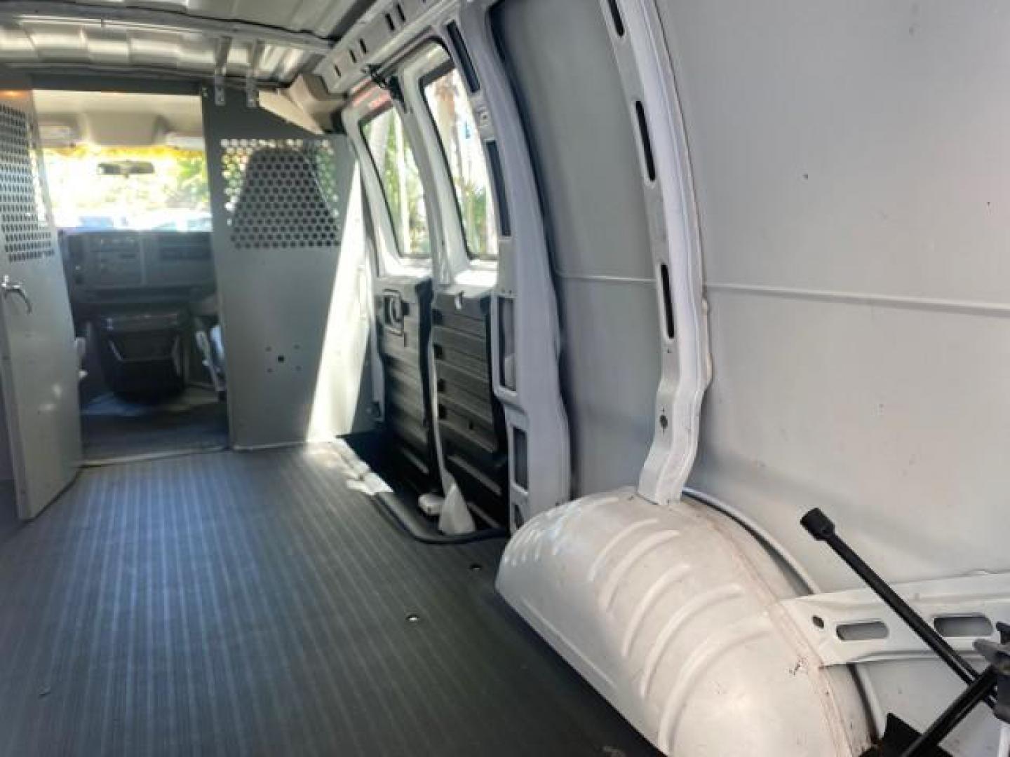 2004 Summit White /Medium Dark Pewter GMC Savana Cargo Van 1 OWNER FL (1GTFG15X141) with an 4.3L Vortec 4300 V6 MFI Engine engine, Automatic transmission, located at 4701 North Dixie Hwy, Pompano Beach, FL, 33064, (954) 422-2889, 26.240938, -80.123474 - OUR WEBPAGE FLORIDACARS1.COM HAS OVER 100 PHOTOS AND FREE CARFAX LINK 2004 GMC SAVANA 1500 THIS VAN IS LIKE NEW! VIN: 1GTFG15X141181482 1 G T F G 1 5 X 1 4 1 1 8 1 4 8 2 VAN 4.3L V6 F GASOLINE REAR WHEEL DRIVE Top Features Conversion Van Vinyl Seats Basic Features ABS Brakes AM/FM Stereo Air Conditi - Photo#81