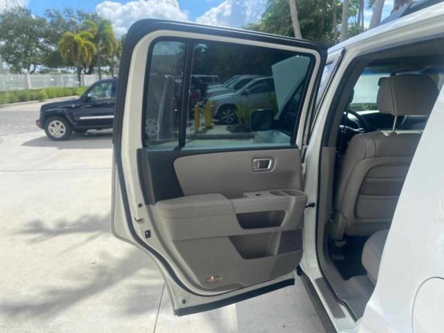2011 Taffeta White /Gray Honda Pilot EX-L FL LOW MILES 93,295 (5FNYF3H58BB) with an 3.5L SOHC MPFI 24-Valve i-VTEC V6 Engine engine, Automatic transmission, located at 4701 North Dixie Hwy, Pompano Beach, FL, 33064, (954) 422-2889, 26.240938, -80.123474 - OUR WEBPAGE FLORIDACARS1.COM HAS OVER 100 PHOTOS AND FREE CARFAX LINK 2011 HONDA PILOT EX-L VIN: 5FNYF3H58BB048398 5 F N Y F 3 H 5 8 B B 0 4 8 3 9 8 4 DOOR WAGON/SPORT UTILITY 3.5L V6 F SOHC 24V GASOLINE FRONT WHEEL DRIVE Features ABS Brakes Air Conditioning Alloy Wheels AM/FM Stereo Automatic Trans - Photo#13