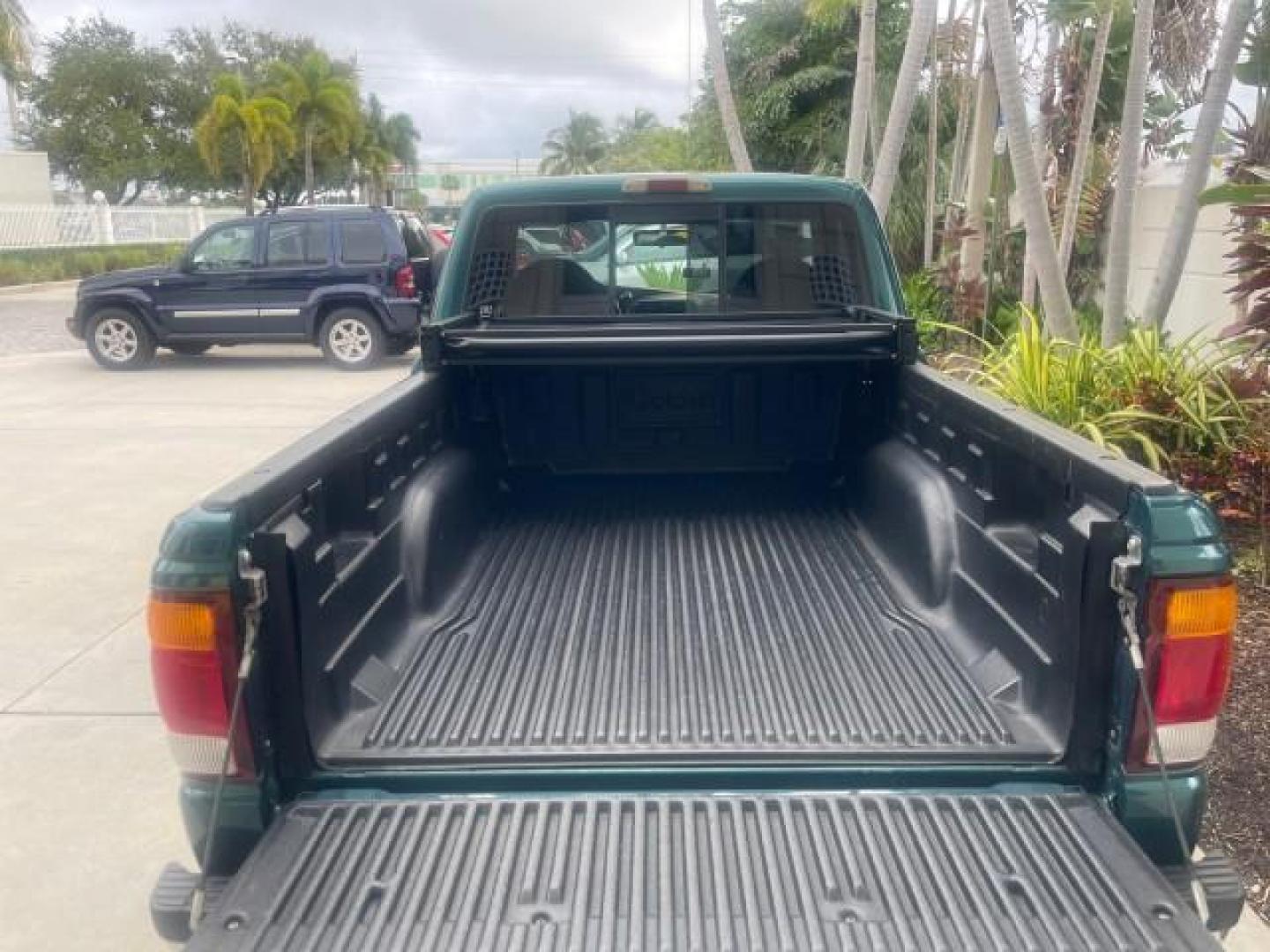 1998 Deep Emerald Green (CC/Met) /Medium Graphite Ford Ranger XL LOW MILES 4 CYL LOW MILES (1FTYR10C0WP) with an 2.5L EFI 4-Cyl Engine engine, Automatic transmission, located at 4701 North Dixie Hwy, Pompano Beach, FL, 33064, (954) 422-2889, 26.240938, -80.123474 - OUR WEBPAGE FLORIDACARS1.COM HAS OVER 100 PHOTOS AND FREE CARFAX LINK 1998 FORD RANGER SPLASH FLARESIDE VIN: 1FTYR10C0WPA84443 1 F T Y R 1 0 C 0 W P A 8 4 4 4 3 PICKUP 2.5L I4 F SOHC 8V GASOLINE 27 MPG REAR WHEEL DRIVE Features ABS Brakes Automatic Transmission Cassette Player Cloth Seats Ice Cold A - Photo#82