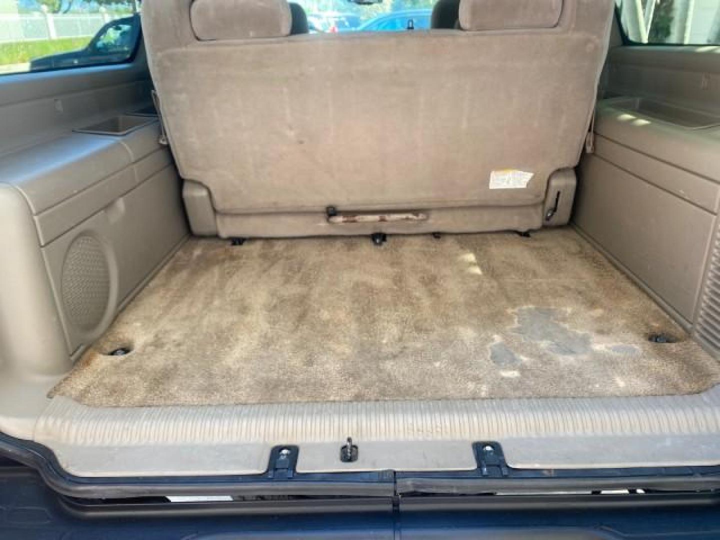 2003 Indigo Blue Metallic /Tan/Neutral Chevrolet Suburban LT 1 OWNER NO ACCIDENTS (1GNEC16Z13R) with an 5.3L Vortec 5300 V8 SFI Bi-Fuel Engine engine, Automatic transmission, located at 4701 North Dixie Hwy, Pompano Beach, FL, 33064, (954) 422-2889, 26.240938, -80.123474 - OUR WEBPAGE FLORIDACARS1.COM HAS OVER 100 PHOTOS AND FREE CARFAX LINK 2003 CHEVROLET SUBURBAN 1500 LS VIN: 1GNEC16Z13R307421 1 G N E C 1 6 Z 1 3 R 3 0 7 4 2 1 4 DOOR WAGON/SPORT UTILITY 5.3L V8 F FLEX FUEL 18 MPG REAR WHEEL DRIVE Features ABS Brakes Air Conditioning Alloy Wheels AM/FM Stereo Automat - Photo#95