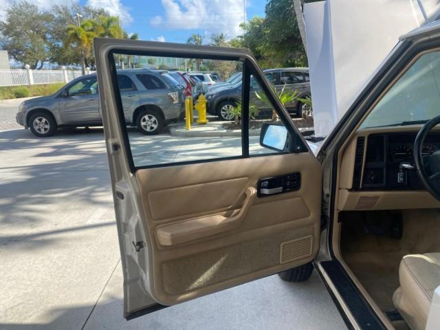 1996 Stone White (CC) /Dark Sand Jeep Cherokee Sport FL LOW MILES 77,388 4WD 4.0 6 CYL (1J4FJ68S2TL) with an 4.0L MPI I6 Engine engine, Automatic transmission, located at 4701 North Dixie Hwy, Pompano Beach, FL, 33064, (954) 422-2889, 26.240938, -80.123474 - OUR WEBPAGE FLORIDACARS1.COM HAS OVER 100 PHOTOS AND FREE CARFAX LINK 1996 JEEP CHEROKEE SPORT 4.0 6 CYL 4WD FL TITLE LOW MILES 77,388 VIN: 1J4FJ68S2TL171877 1 J 4 F J 6 8 S 2 T L 1 7 1 8 7 7 4 DOOR WAGON/SPORT UTILITY 4.0L I6 F GASOLINE REAR WHEEL DRIVE W/ 4X4 Top Features Cloth Seats Basic Feature- Photo#9
