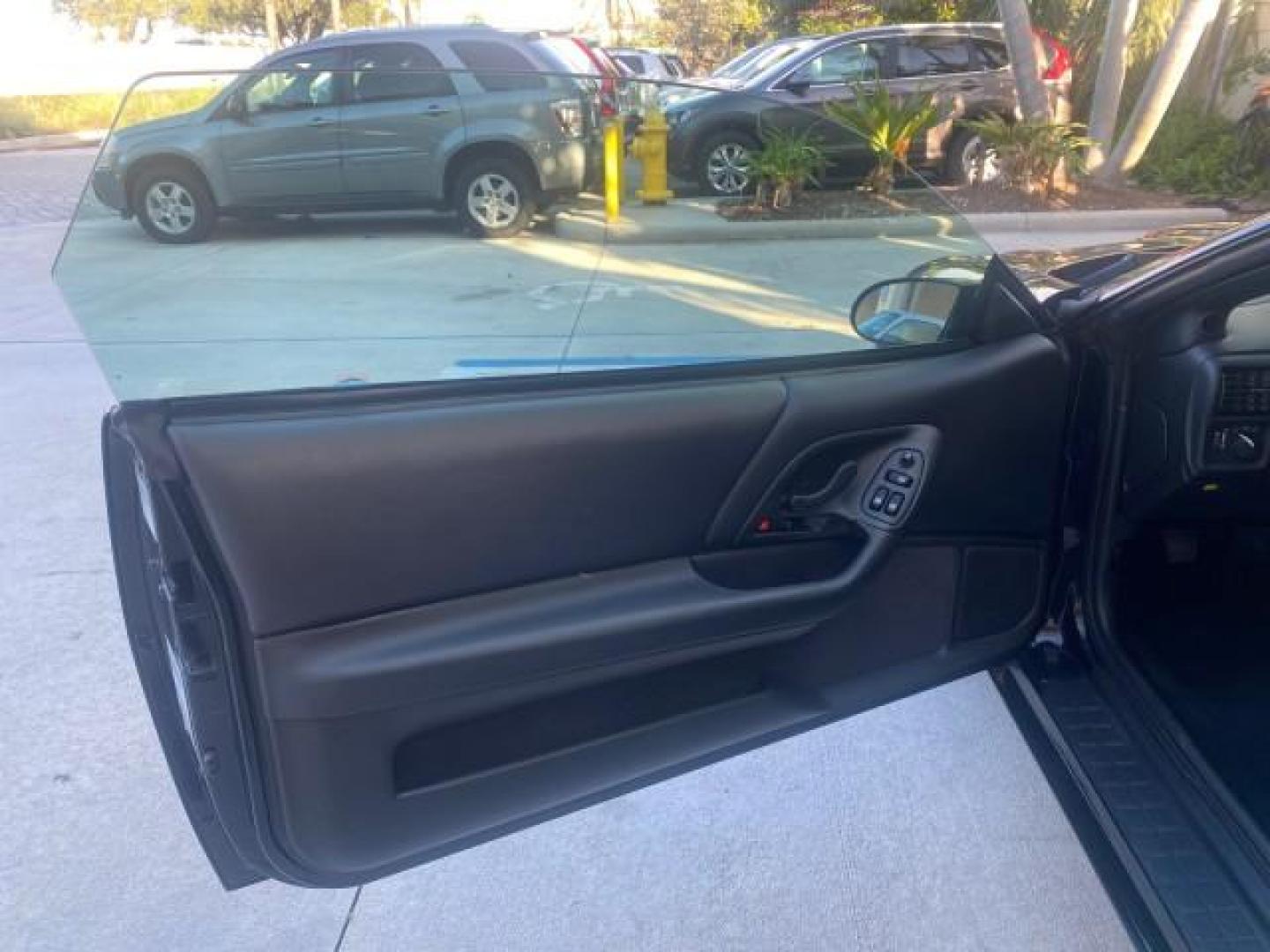 2002 Black /Ebony Chevrolet Camaro Z28 CONV 6 SPD LOW MILES 29,016 (2G1FP32G622) with an 5.7L SFI V8 Engine engine, Manual transmission, located at 4701 North Dixie Hwy, Pompano Beach, FL, 33064, (954) 422-2889, 26.240938, -80.123474 - OUR WEBPAGE FLORIDACARS1.COM HAS OVER 100 PHOTOS AND FREE CARFAX LINK 2002 CHEVROLET CAMARO Z28 6 SPEED ALL ORIGINAL PAINT VERY LOW MILES VIN: 2G1FP32G622129985 2 G 1 F P 3 2 G 6 2 2 1 2 9 9 8 5 CONVERTIBLE 5.7L V8 F OHV GASOLINE 25 MPG REAR WHEEL DRIVE Features ABS Brakes Air Conditioning Alloy Whe - Photo#61