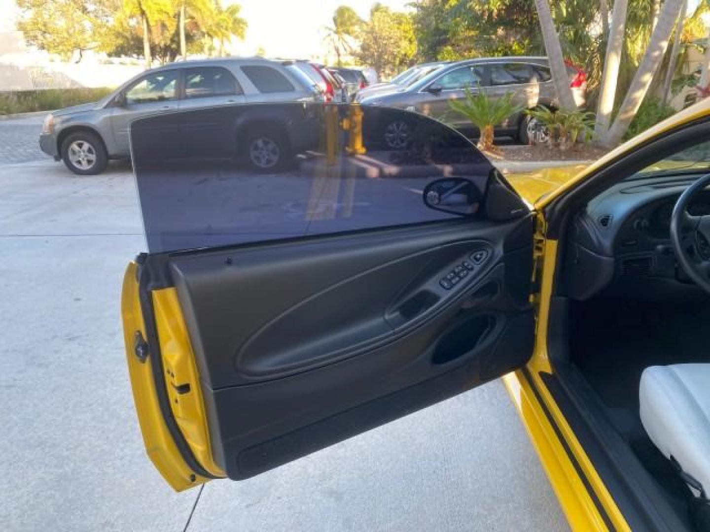 1999 Chrome Yellow /Oxford White Ford Mustang GT LOW MILES 8,145 1 OWNER FL CONV (1FAFP45X3XF) with an 4.6L SOHC SMPI V8 Engine engine, Automatic transmission, located at 4701 North Dixie Hwy, Pompano Beach, FL, 33064, (954) 422-2889, 26.240938, -80.123474 - OUR WEBPAGE FLORIDACARS1.COM HAS OVER 100 PHOTOS AND FREE CARFAX LINK 1999 FORD MUSTANG GT 1 OWNER VIN: 1FAFP45X3XF127745 1 F A F P 4 5 X 3 X F 1 2 7 7 4 5 CONVERTIBLE 4.6L V8 F SOHC 16V GASOLINE 24 MPG REAR WHEEL DRIVE Features ABS Brakes Air Conditioning Alloy Wheels AM/FM Stereo Automatic Transmi - Photo#9