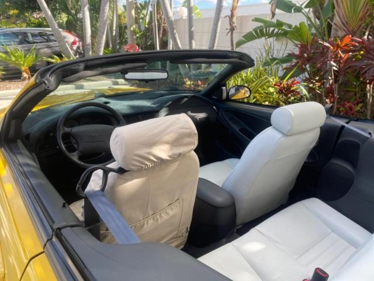 1999 Chrome Yellow /Oxford White Ford Mustang GT LOW MILES 8,145 1 OWNER FL CONV (1FAFP45X3XF) with an 4.6L SOHC SMPI V8 Engine engine, Automatic transmission, located at 4701 North Dixie Hwy, Pompano Beach, FL, 33064, (954) 422-2889, 26.240938, -80.123474 - OUR WEBPAGE FLORIDACARS1.COM HAS OVER 100 PHOTOS AND FREE CARFAX LINK 1999 FORD MUSTANG GT 1 OWNER VIN: 1FAFP45X3XF127745 1 F A F P 4 5 X 3 X F 1 2 7 7 4 5 CONVERTIBLE 4.6L V8 F SOHC 16V GASOLINE 24 MPG REAR WHEEL DRIVE Features ABS Brakes Air Conditioning Alloy Wheels AM/FM Stereo Automatic Transmi - Photo#47
