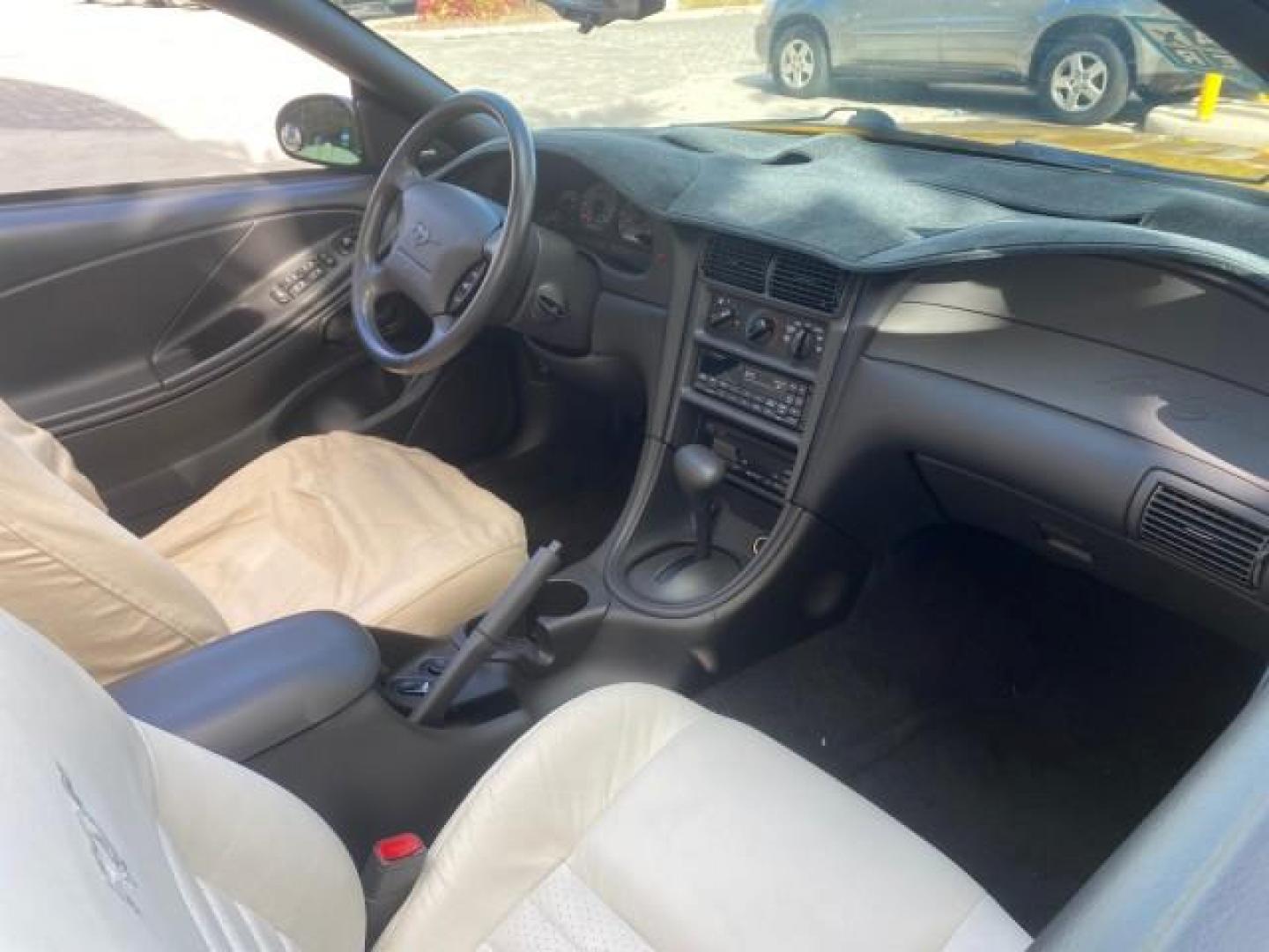 1999 Chrome Yellow /Oxford White Ford Mustang GT LOW MILES 8,145 1 OWNER FL CONV (1FAFP45X3XF) with an 4.6L SOHC SMPI V8 Engine engine, Automatic transmission, located at 4701 North Dixie Hwy, Pompano Beach, FL, 33064, (954) 422-2889, 26.240938, -80.123474 - OUR WEBPAGE FLORIDACARS1.COM HAS OVER 100 PHOTOS AND FREE CARFAX LINK 1999 FORD MUSTANG GT 1 OWNER VIN: 1FAFP45X3XF127745 1 F A F P 4 5 X 3 X F 1 2 7 7 4 5 CONVERTIBLE 4.6L V8 F SOHC 16V GASOLINE 24 MPG REAR WHEEL DRIVE Features ABS Brakes Air Conditioning Alloy Wheels AM/FM Stereo Automatic Transmi - Photo#53