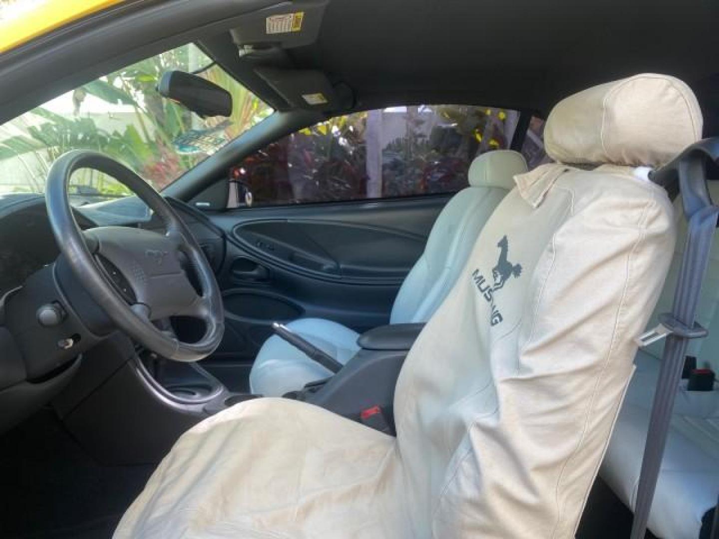 1999 Chrome Yellow /Oxford White Ford Mustang GT LOW MILES 8,145 1 OWNER FL CONV (1FAFP45X3XF) with an 4.6L SOHC SMPI V8 Engine engine, Automatic transmission, located at 4701 North Dixie Hwy, Pompano Beach, FL, 33064, (954) 422-2889, 26.240938, -80.123474 - OUR WEBPAGE FLORIDACARS1.COM HAS OVER 100 PHOTOS AND FREE CARFAX LINK 1999 FORD MUSTANG GT 1 OWNER VIN: 1FAFP45X3XF127745 1 F A F P 4 5 X 3 X F 1 2 7 7 4 5 CONVERTIBLE 4.6L V8 F SOHC 16V GASOLINE 24 MPG REAR WHEEL DRIVE Features ABS Brakes Air Conditioning Alloy Wheels AM/FM Stereo Automatic Transmi - Photo#72