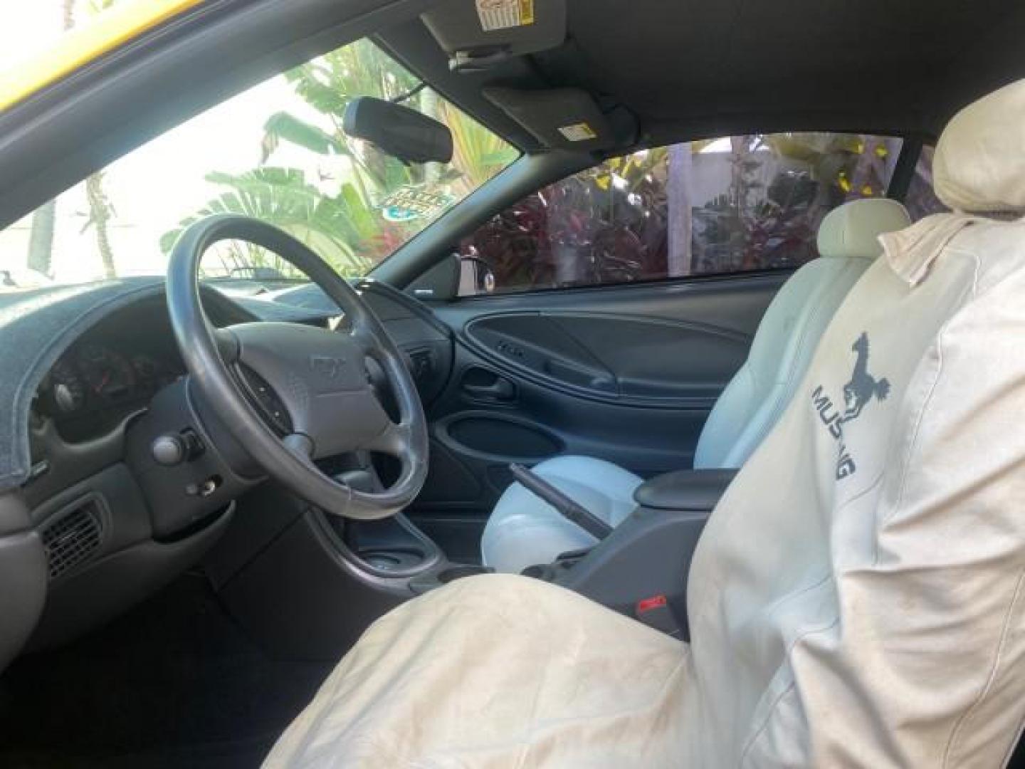 1999 Chrome Yellow /Oxford White Ford Mustang GT LOW MILES 8,145 1 OWNER FL CONV (1FAFP45X3XF) with an 4.6L SOHC SMPI V8 Engine engine, Automatic transmission, located at 4701 North Dixie Hwy, Pompano Beach, FL, 33064, (954) 422-2889, 26.240938, -80.123474 - OUR WEBPAGE FLORIDACARS1.COM HAS OVER 100 PHOTOS AND FREE CARFAX LINK 1999 FORD MUSTANG GT 1 OWNER VIN: 1FAFP45X3XF127745 1 F A F P 4 5 X 3 X F 1 2 7 7 4 5 CONVERTIBLE 4.6L V8 F SOHC 16V GASOLINE 24 MPG REAR WHEEL DRIVE Features ABS Brakes Air Conditioning Alloy Wheels AM/FM Stereo Automatic Transmi - Photo#73