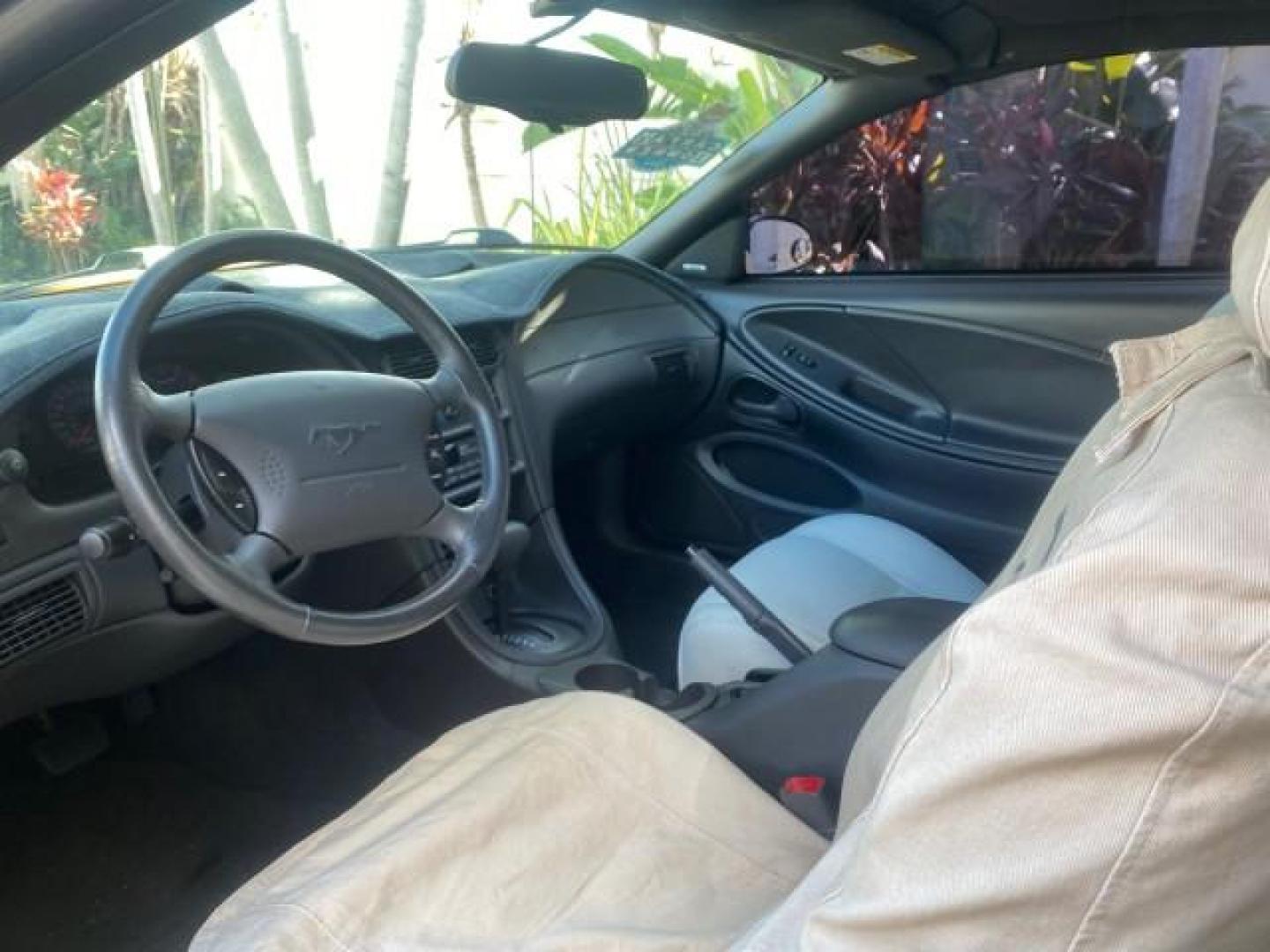 1999 Chrome Yellow /Oxford White Ford Mustang GT LOW MILES 8,145 1 OWNER FL CONV (1FAFP45X3XF) with an 4.6L SOHC SMPI V8 Engine engine, Automatic transmission, located at 4701 North Dixie Hwy, Pompano Beach, FL, 33064, (954) 422-2889, 26.240938, -80.123474 - OUR WEBPAGE FLORIDACARS1.COM HAS OVER 100 PHOTOS AND FREE CARFAX LINK 1999 FORD MUSTANG GT 1 OWNER VIN: 1FAFP45X3XF127745 1 F A F P 4 5 X 3 X F 1 2 7 7 4 5 CONVERTIBLE 4.6L V8 F SOHC 16V GASOLINE 24 MPG REAR WHEEL DRIVE Features ABS Brakes Air Conditioning Alloy Wheels AM/FM Stereo Automatic Transmi - Photo#74