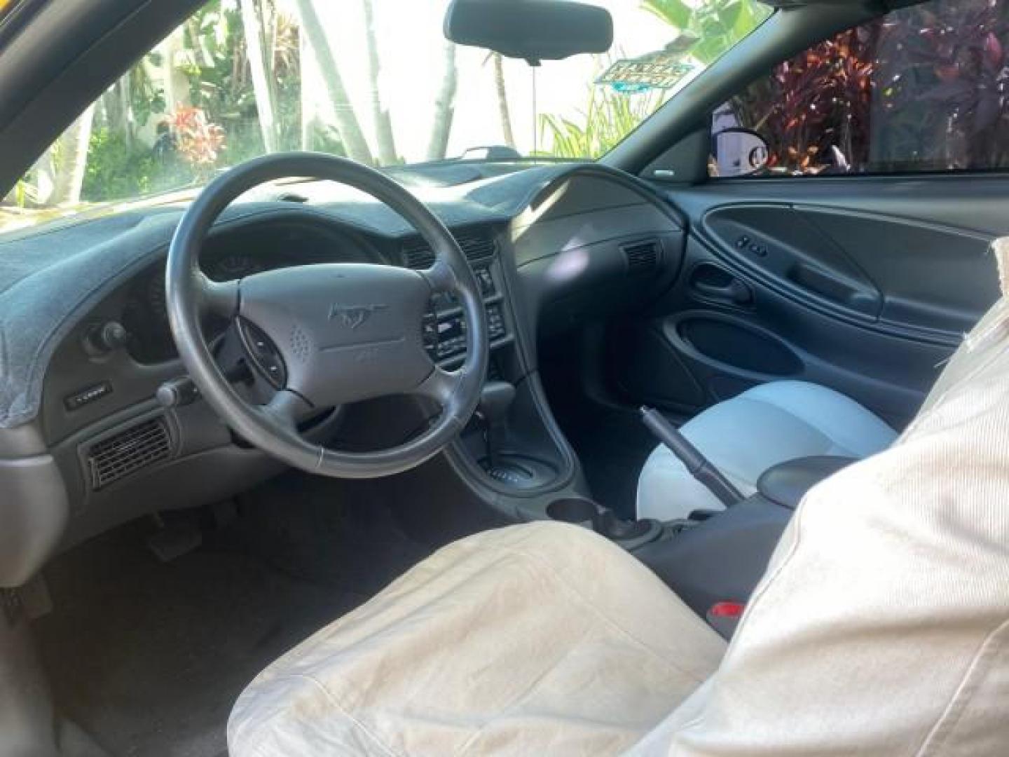 1999 Chrome Yellow /Oxford White Ford Mustang GT LOW MILES 8,145 1 OWNER FL CONV (1FAFP45X3XF) with an 4.6L SOHC SMPI V8 Engine engine, Automatic transmission, located at 4701 North Dixie Hwy, Pompano Beach, FL, 33064, (954) 422-2889, 26.240938, -80.123474 - OUR WEBPAGE FLORIDACARS1.COM HAS OVER 100 PHOTOS AND FREE CARFAX LINK 1999 FORD MUSTANG GT 1 OWNER VIN: 1FAFP45X3XF127745 1 F A F P 4 5 X 3 X F 1 2 7 7 4 5 CONVERTIBLE 4.6L V8 F SOHC 16V GASOLINE 24 MPG REAR WHEEL DRIVE Features ABS Brakes Air Conditioning Alloy Wheels AM/FM Stereo Automatic Transmi - Photo#75