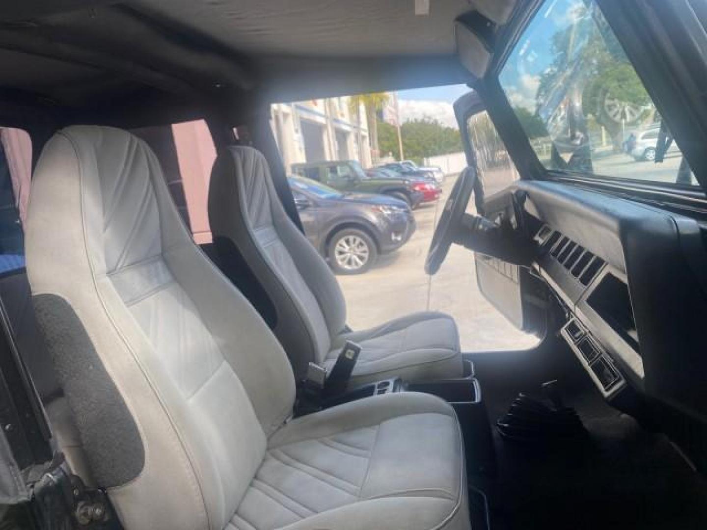 1994 Black /Gray Jeep Wrangler 4.0 6 CYL SE LOW MILES 87,813 (1J4FY29S8RP) with an 4.0L Straight 6-Cyl Engine engine, Automatic transmission, located at 4701 North Dixie Hwy, Pompano Beach, FL, 33064, (954) 422-2889, 26.240938, -80.123474 - OUR WEBPAGE FLORIDACARS1.COM HAS OVER 100 PHOTOS AND FREE CARFAX LINK 1994 JEEP WRANGLER SE AUTO AC BRAND NEW TOP WITH HARDWARE $ 2000 VALUE INCLUDED VIN: 1J4FY29S8RP433289 1 J 4 F Y 2 9 S 8 R P 4 3 3 2 8 9 UTILITY (BLAZER, JIMMY, SCOUT, ETC.) 4.0L I6 F GASOLINE REAR WHEEL DRIVE W/ 4X4 Features ABS - Photo#12