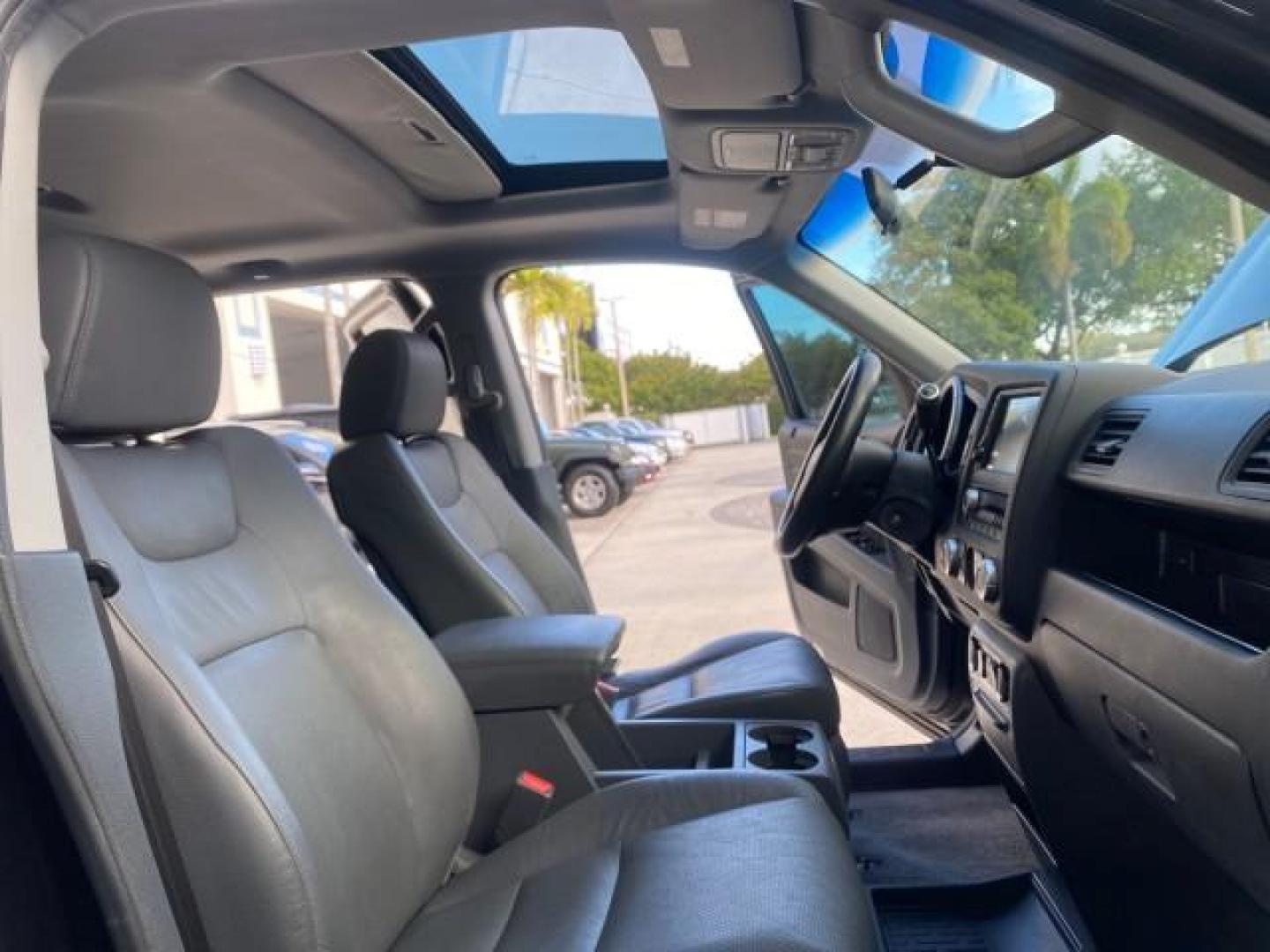 2007 Formal Black /Gray Honda Ridgeline RTL w/Leather 1 OWNER FL (2HJYK16557H) with an 3.5L SOHC PGM-FI 24-Valve VTEC V6 Engine engine, Automatic transmission, located at 4701 North Dixie Hwy, Pompano Beach, FL, 33064, (954) 422-2889, 26.240938, -80.123474 - OUR WEBPAGE FLORIDACARS1.COM HAS OVER 100 PHOTOS AND FREE CARFAX LINK 2007 HONDA RIDGELINE RTL 1 OWNER NEW $35,535 VIN: 2HJYK16557H543559 2 H J Y K 1 6 5 5 7 H 5 4 3 5 5 9 CREW PICKUP 3.5L V6 F SOHC 24V GASOLINE 21 MPG FRONT WHEEL DRIVE W/ 4X4 Features ABS Brakes Air Conditioning Alloy Wheels AM/FM - Photo#12