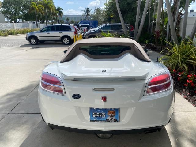 2007 Polar White /Tan Saturn Sky LOW MILES 21,329 5 SPEED MANUAL (1G8MB35B47Y) with an 2.4L DOHC VVT I4 Aluminum Ecotec Engine engine, Manual transmission, located at 4701 North Dixie Hwy, Pompano Beach, FL, 33064, (954) 422-2889, 26.240938, -80.123474 - OUR WEBPAGE FLORIDACARS1.COM HAS OVER 100 PHOTOS AND FREE CARFAX LINK 2007 Saturn SKY 5 SPEED MANUAL Convertible 2.4L I4 F DOHC Gasoline 28 MPG Rear Wheel Drive Features ABS Brakes Air Conditioning Alloy Wheels AM/FM Stereo Auxiliary Audio Input CD Audio Cruise Control Leather Seats Manual Transmiss - Photo#35