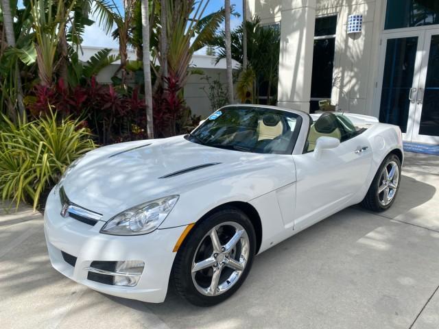 2007 Polar White /Tan Saturn Sky LOW MILES 21,329 5 SPEED MANUAL (1G8MB35B47Y) with an 2.4L DOHC VVT I4 Aluminum Ecotec Engine engine, Manual transmission, located at 4701 North Dixie Hwy, Pompano Beach, FL, 33064, (954) 422-2889, 26.240938, -80.123474 - OUR WEBPAGE FLORIDACARS1.COM HAS OVER 100 PHOTOS AND FREE CARFAX LINK 2007 Saturn SKY 5 SPEED MANUAL Convertible 2.4L I4 F DOHC Gasoline 28 MPG Rear Wheel Drive Features ABS Brakes Air Conditioning Alloy Wheels AM/FM Stereo Auxiliary Audio Input CD Audio Cruise Control Leather Seats Manual Transmiss - Photo#39