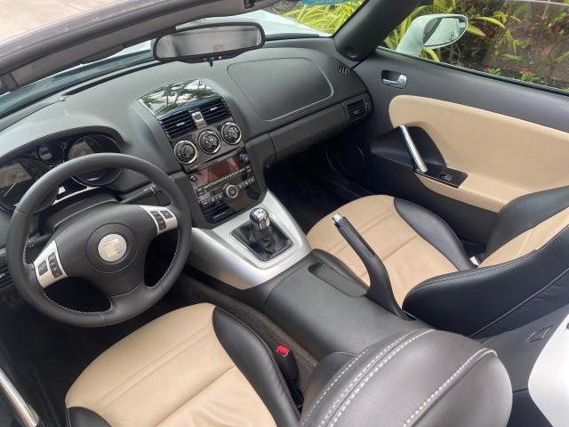 2007 Polar White /Tan Saturn Sky LOW MILES 21,329 5 SPEED MANUAL (1G8MB35B47Y) with an 2.4L DOHC VVT I4 Aluminum Ecotec Engine engine, Manual transmission, located at 4701 North Dixie Hwy, Pompano Beach, FL, 33064, (954) 422-2889, 26.240938, -80.123474 - OUR WEBPAGE FLORIDACARS1.COM HAS OVER 100 PHOTOS AND FREE CARFAX LINK 2007 Saturn SKY 5 SPEED MANUAL Convertible 2.4L I4 F DOHC Gasoline 28 MPG Rear Wheel Drive Features ABS Brakes Air Conditioning Alloy Wheels AM/FM Stereo Auxiliary Audio Input CD Audio Cruise Control Leather Seats Manual Transmiss - Photo#48