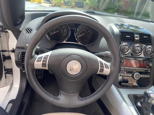2007 Polar White /Tan Saturn Sky LOW MILES 21,329 5 SPEED MANUAL (1G8MB35B47Y) with an 2.4L DOHC VVT I4 Aluminum Ecotec Engine engine, Manual transmission, located at 4701 North Dixie Hwy, Pompano Beach, FL, 33064, (954) 422-2889, 26.240938, -80.123474 - OUR WEBPAGE FLORIDACARS1.COM HAS OVER 100 PHOTOS AND FREE CARFAX LINK 2007 Saturn SKY 5 SPEED MANUAL Convertible 2.4L I4 F DOHC Gasoline 28 MPG Rear Wheel Drive Features ABS Brakes Air Conditioning Alloy Wheels AM/FM Stereo Auxiliary Audio Input CD Audio Cruise Control Leather Seats Manual Transmiss - Photo#66
