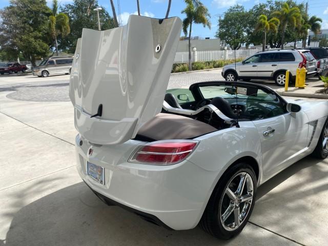 2007 Polar White /Tan Saturn Sky LOW MILES 21,329 5 SPEED MANUAL (1G8MB35B47Y) with an 2.4L DOHC VVT I4 Aluminum Ecotec Engine engine, Manual transmission, located at 4701 North Dixie Hwy, Pompano Beach, FL, 33064, (954) 422-2889, 26.240938, -80.123474 - OUR WEBPAGE FLORIDACARS1.COM HAS OVER 100 PHOTOS AND FREE CARFAX LINK 2007 Saturn SKY 5 SPEED MANUAL Convertible 2.4L I4 F DOHC Gasoline 28 MPG Rear Wheel Drive Features ABS Brakes Air Conditioning Alloy Wheels AM/FM Stereo Auxiliary Audio Input CD Audio Cruise Control Leather Seats Manual Transmiss - Photo#95