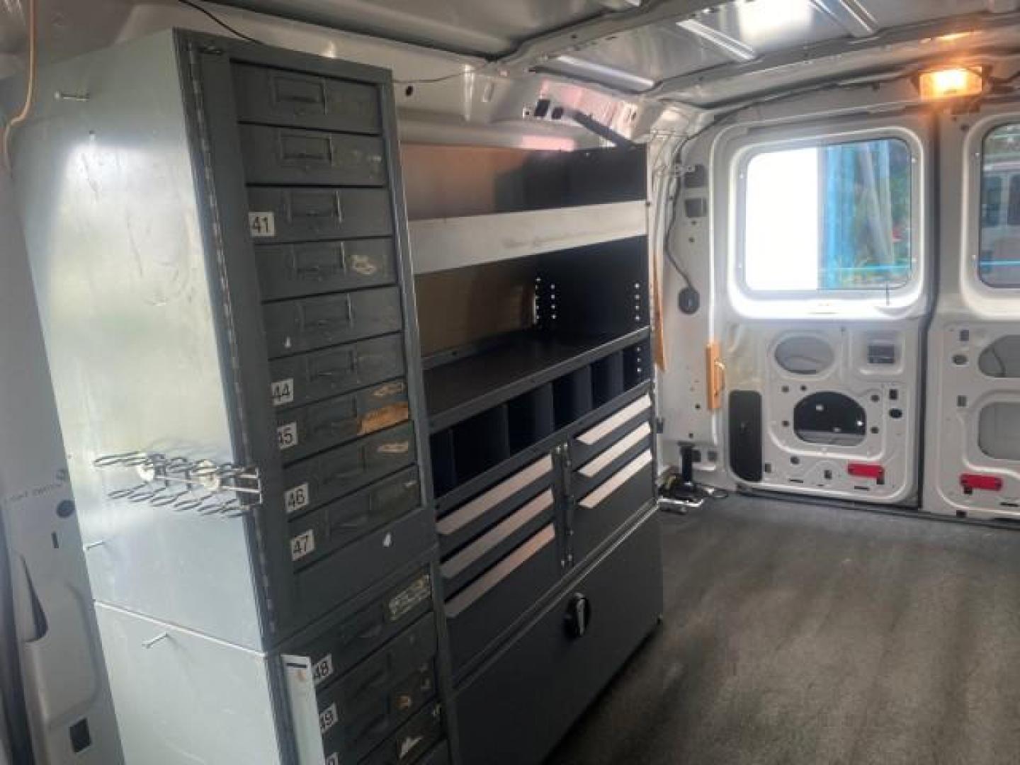 2014 Oxford White /Medium Flint Ford Econoline Cargo Van EXTENDED LOW MILES 6,380 1 OWNER (1FTNS1EW3ED) with an 4.6L EFI V8 FFV Capable Engine engine, Automatic transmission, located at 4701 North Dixie Hwy, Pompano Beach, FL, 33064, (954) 422-2889, 26.240938, -80.123474 - OUR WEBPAGE FLORIDACARS1.COM HAS OVER 100 PHOTOS AND FREE CARFAX LINK 2014 Ford E-Series E-150 1 OWNER Van 4.6L V8 F SOHC 16V Gasoline 16 MPG Rear Wheel Drive Features ABS Brakes Air Conditioning AM/FM Stereo Automatic Transmission Auxiliary Audio Input Barn Doors Power Locks Traction Control Vinyl - Photo#80