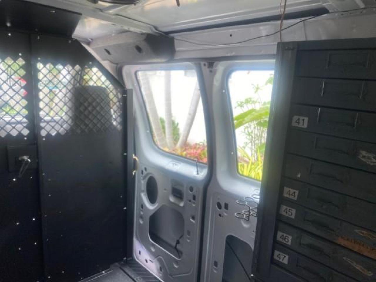 2014 Oxford White /Medium Flint Ford Econoline Cargo Van EXTENDED LOW MILES 6,380 1 OWNER (1FTNS1EW3ED) with an 4.6L EFI V8 FFV Capable Engine engine, Automatic transmission, located at 4701 North Dixie Hwy, Pompano Beach, FL, 33064, (954) 422-2889, 26.240938, -80.123474 - OUR WEBPAGE FLORIDACARS1.COM HAS OVER 100 PHOTOS AND FREE CARFAX LINK 2014 Ford E-Series E-150 1 OWNER Van 4.6L V8 F SOHC 16V Gasoline 16 MPG Rear Wheel Drive Features ABS Brakes Air Conditioning AM/FM Stereo Automatic Transmission Auxiliary Audio Input Barn Doors Power Locks Traction Control Vinyl - Photo#90