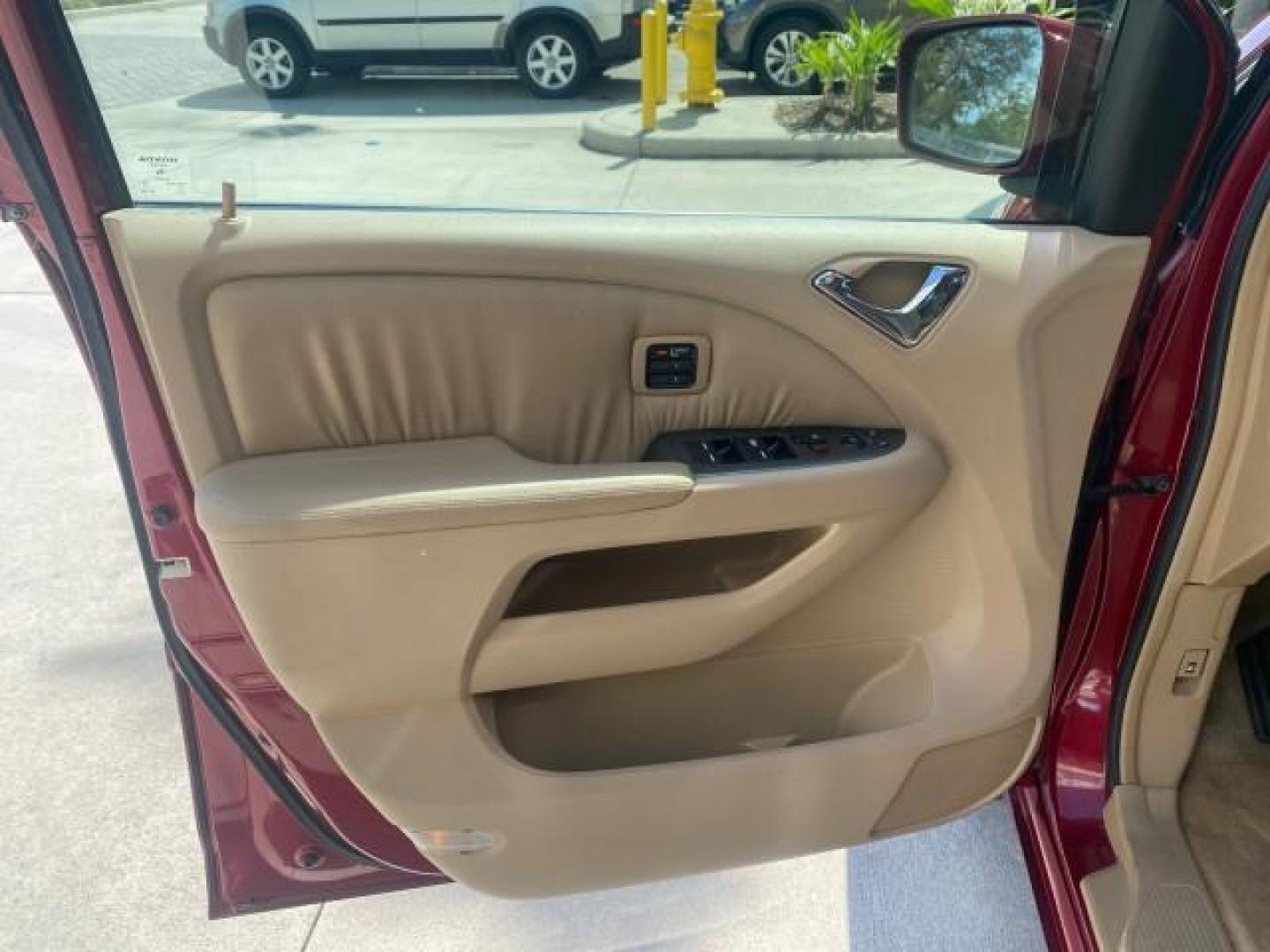 2005 Redrock Pearl /Ivory Honda Odyssey TOURING LOW MILES 62,337 FL (5FNRL38815B) with an 3.5L SOHC MPFI 24-Valve i-VTEC V6 Engine engine, Automatic transmission, located at 4701 North Dixie Hwy, Pompano Beach, FL, 33064, (954) 422-2889, 26.240938, -80.123474 - OUR WEBPAGE FLORIDACARS1.COM HAS OVER 100 PHOTOS AND FREE CARFAX LINK 2005 Honda Odyssey Touring LOADED LEATHER SUNROOF NAVIGATION Van 3.5L V6 F SOHC 24V Gasoline 28 MPG Front Wheel Drive Features ABS Brakes Air Conditioning Alloy Wheels AM/FM Stereo Automatic Transmission Auxiliary Audio Input CD A- Photo#39