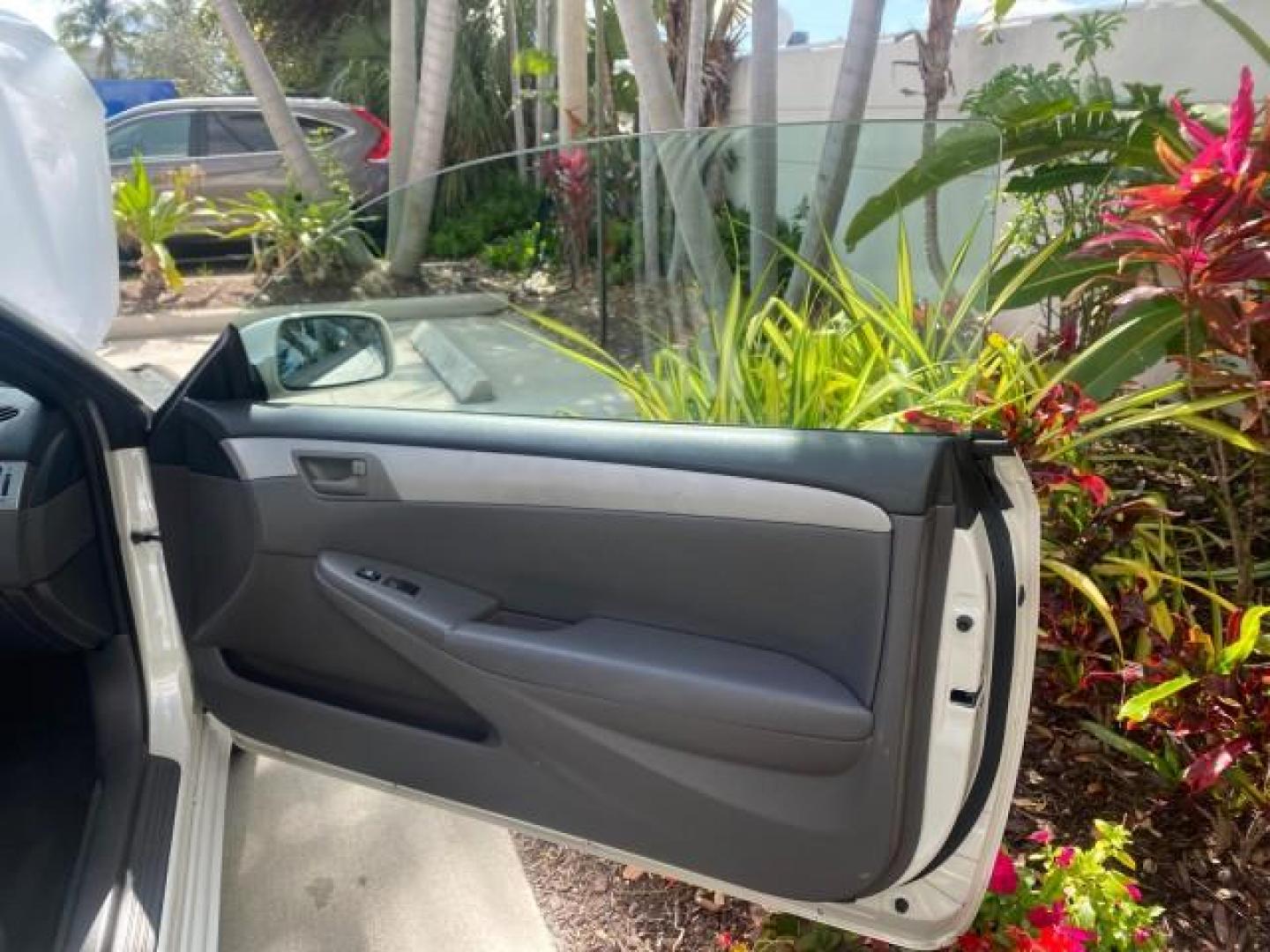 2008 Blizzard White Pearl /Dark Gray Toyota Camry Solara SE CONVERTIBLE LOW MILES 74,665 (4T1FA38PX8U) with an 3.3L DOHC SMPI VVT-i 24-Valve V6 Engine engine, Automatic transmission, located at 4701 North Dixie Hwy, Pompano Beach, FL, 33064, (954) 422-2889, 26.240938, -80.123474 - OUR WEBPAGE FLORIDACARS1.COM HAS OVER 100 PHOTOS AND FREE CARFAX LINK 2008 Toyota Camry Solara SE V6 Convertible 3.3L V6 F DOHC 24V Gasoline 29 MPG Front Wheel Drive Features ABS Brakes Air Conditioning Alloy Wheels AM/FM Stereo Automatic Transmission Auxiliary Audio Input CD Audio Cruise Control Le- Photo#11